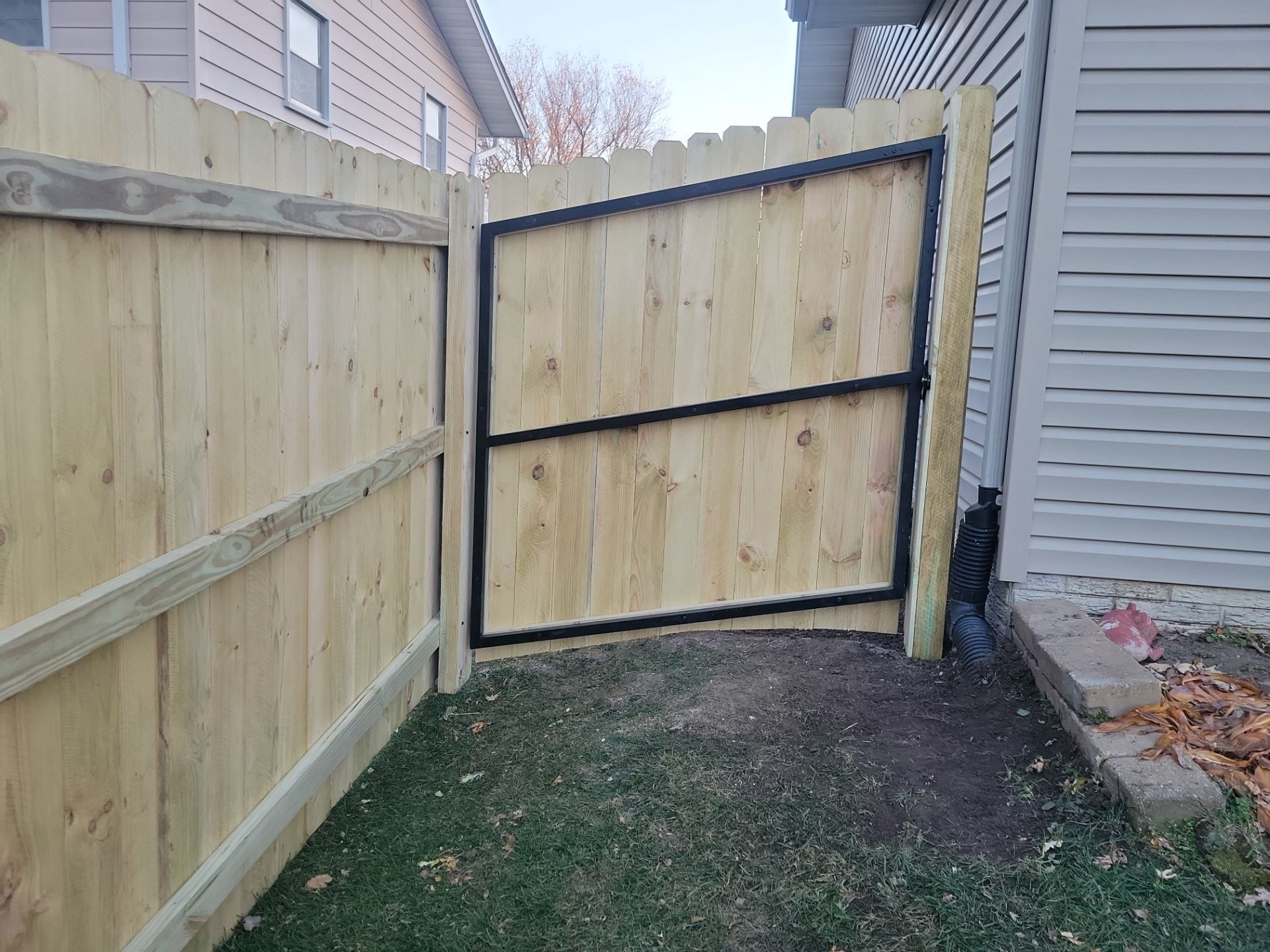 New Pressure-Treated Wood Privacy Fence and Gate in Charles City by Perfect Picket Fence and Stain