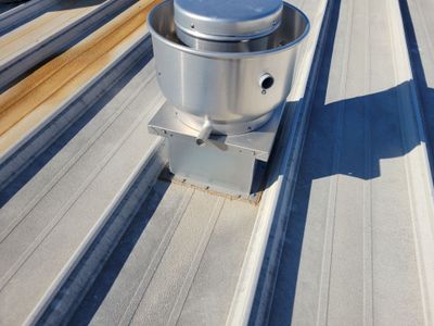 Metal roof ventilation unit on a standing seam roof