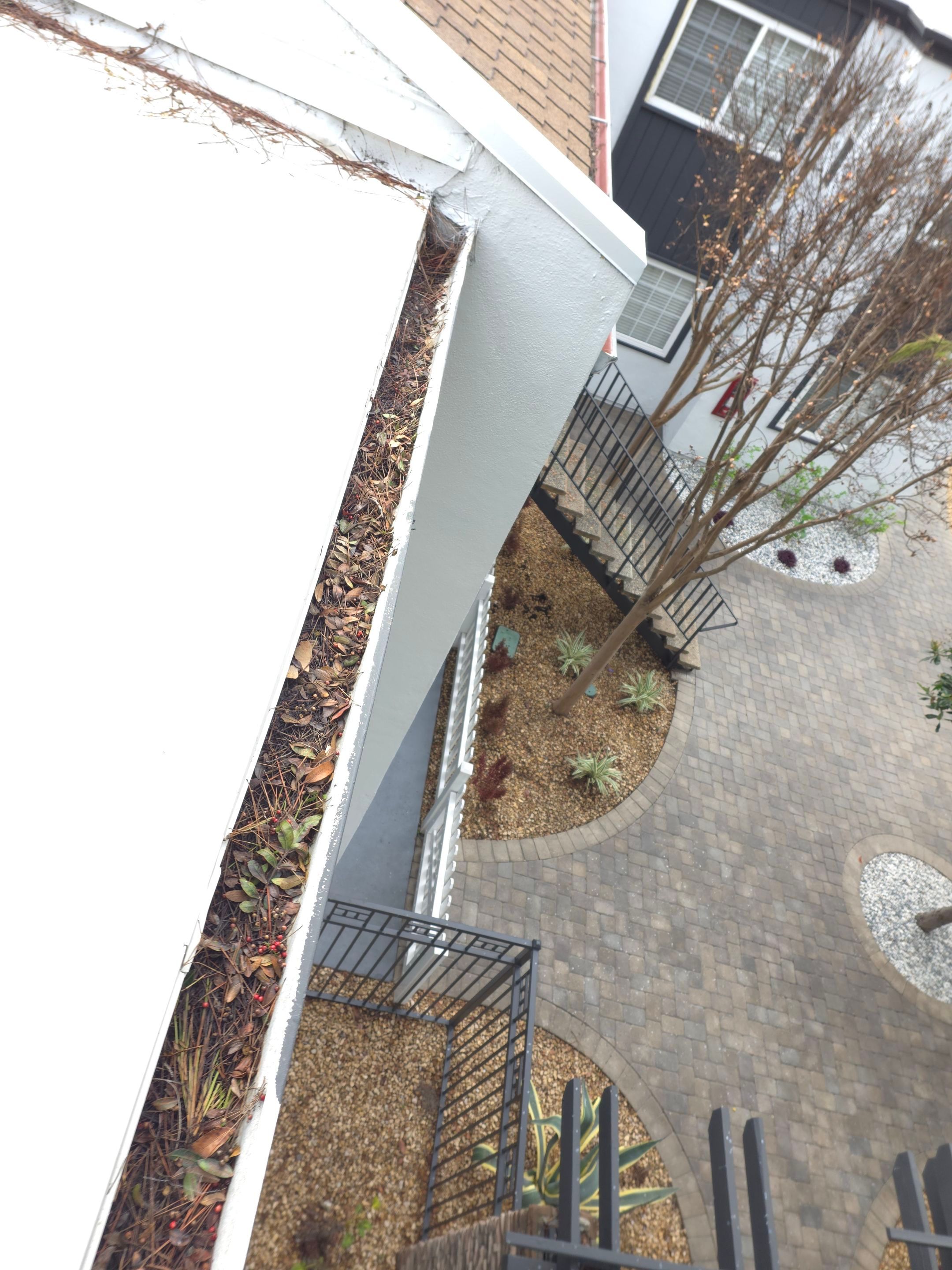 Commercial gutter cleaning Irvine & Newport Beach before photo with filled gutters