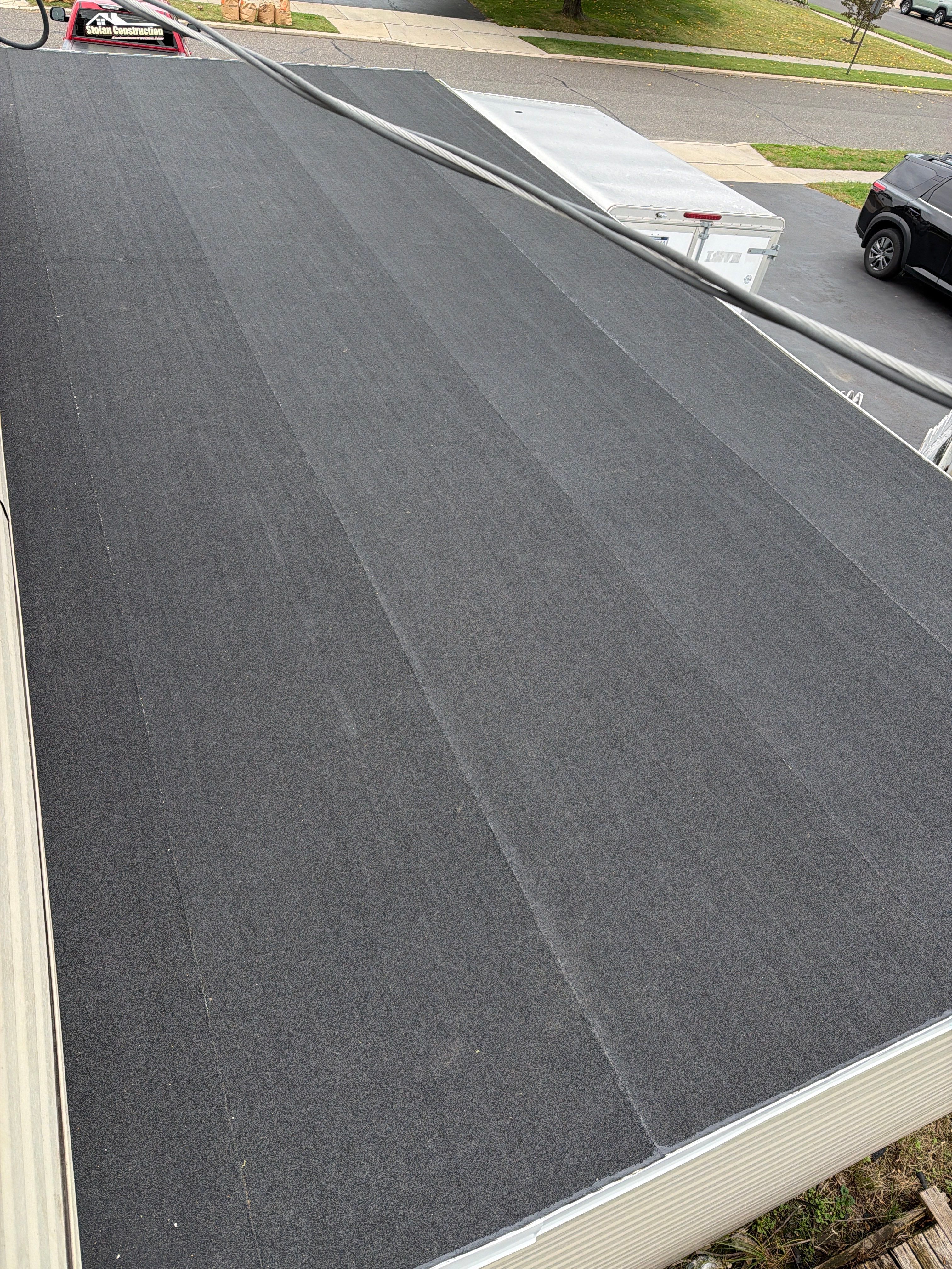 Flat Roof Replacement and Shingle Integration in Levittown by Stofan Construction LLC