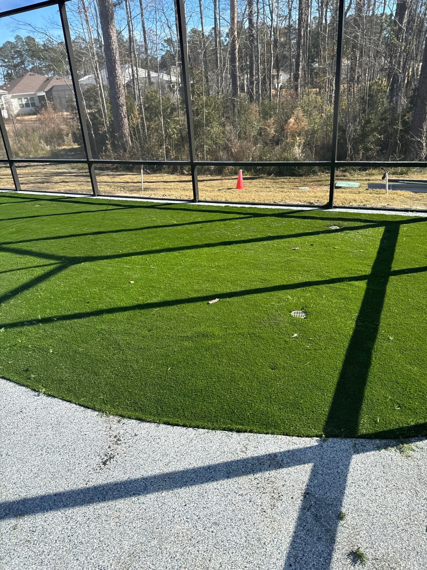 Hardeeville Screened-In Concrete Patio and Integrated Artificial Turf by Lowcountry Scapes, LLC