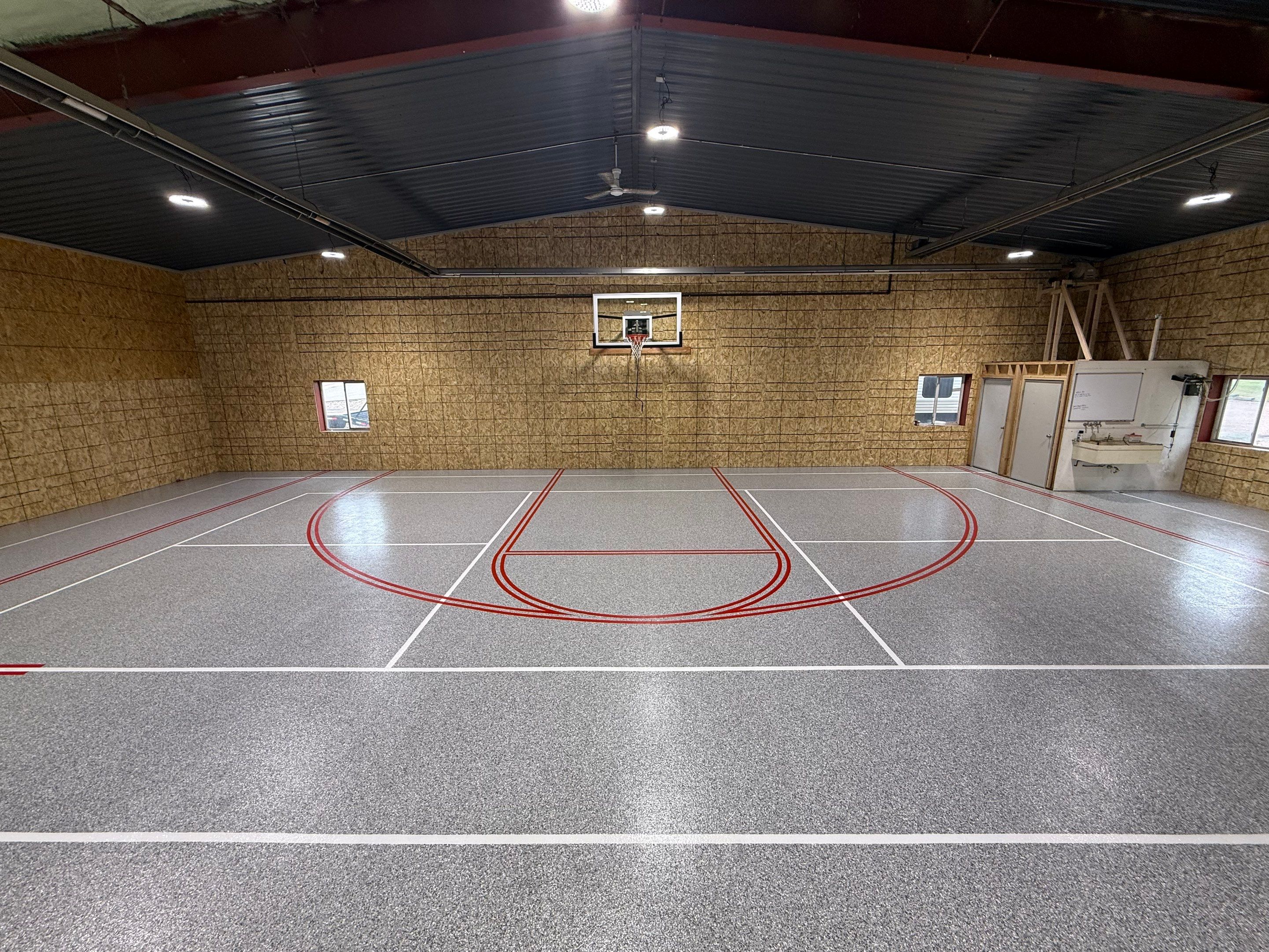 Custom Polyurea Shop Floor with Basketball Court Lines in Rock Valley by Select Painting, Coatings & Garage Cabinets