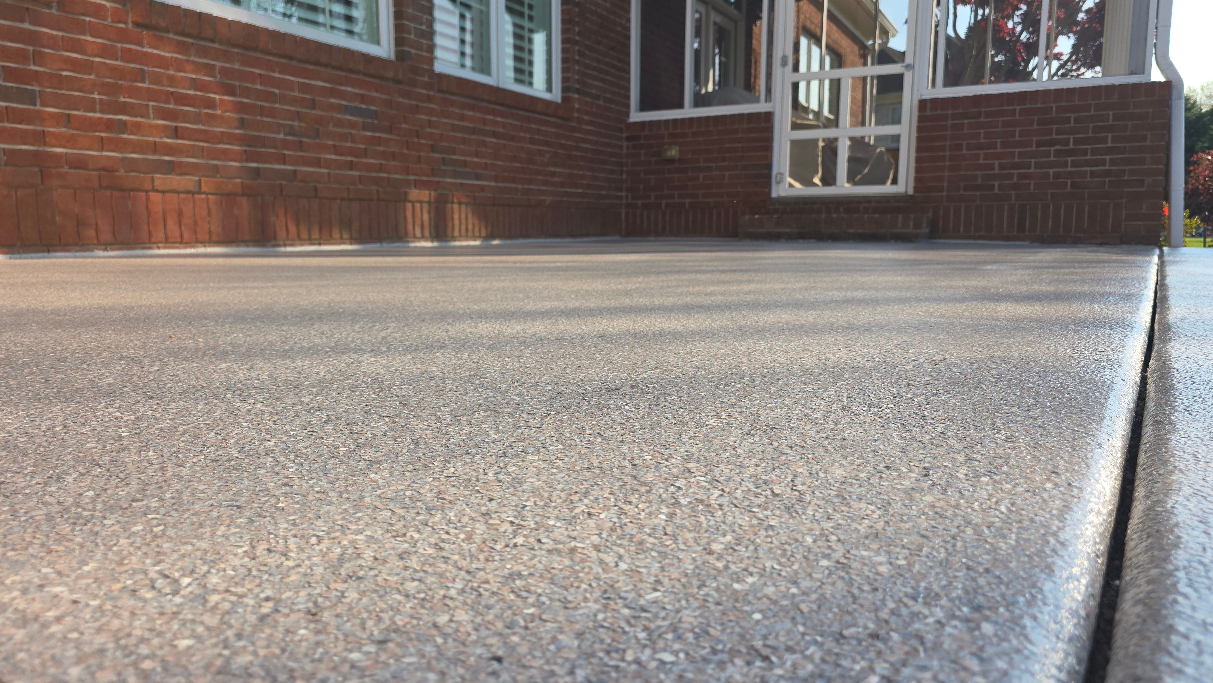 Patio in Pumice with Obsidian Border  by Elite Floor Solutions