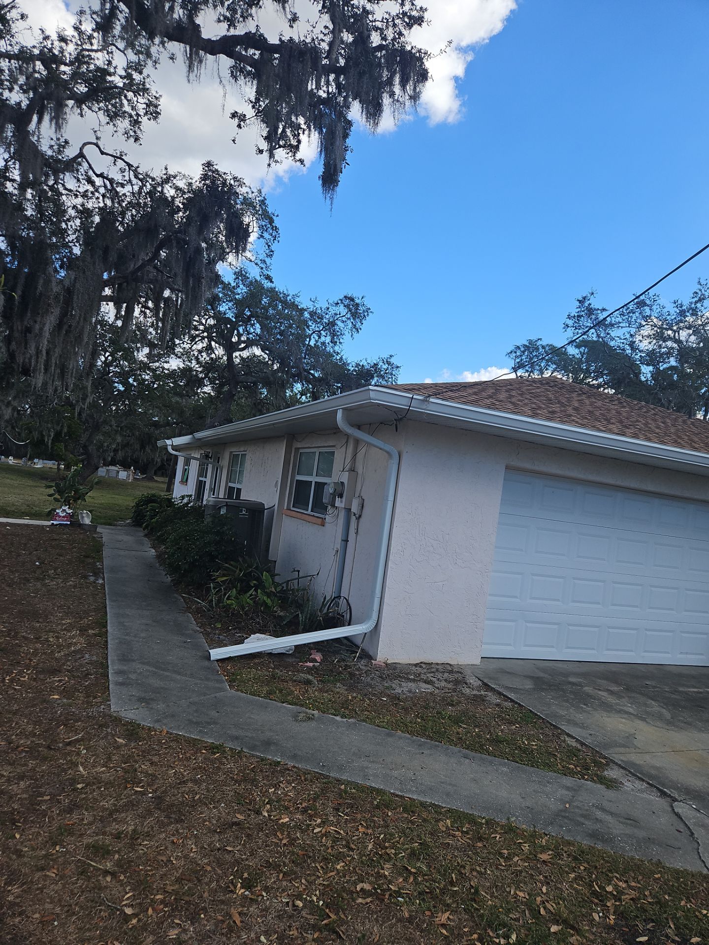 Downspout Installation using White Down Spouts in Sarasota FL by Gutter Professors