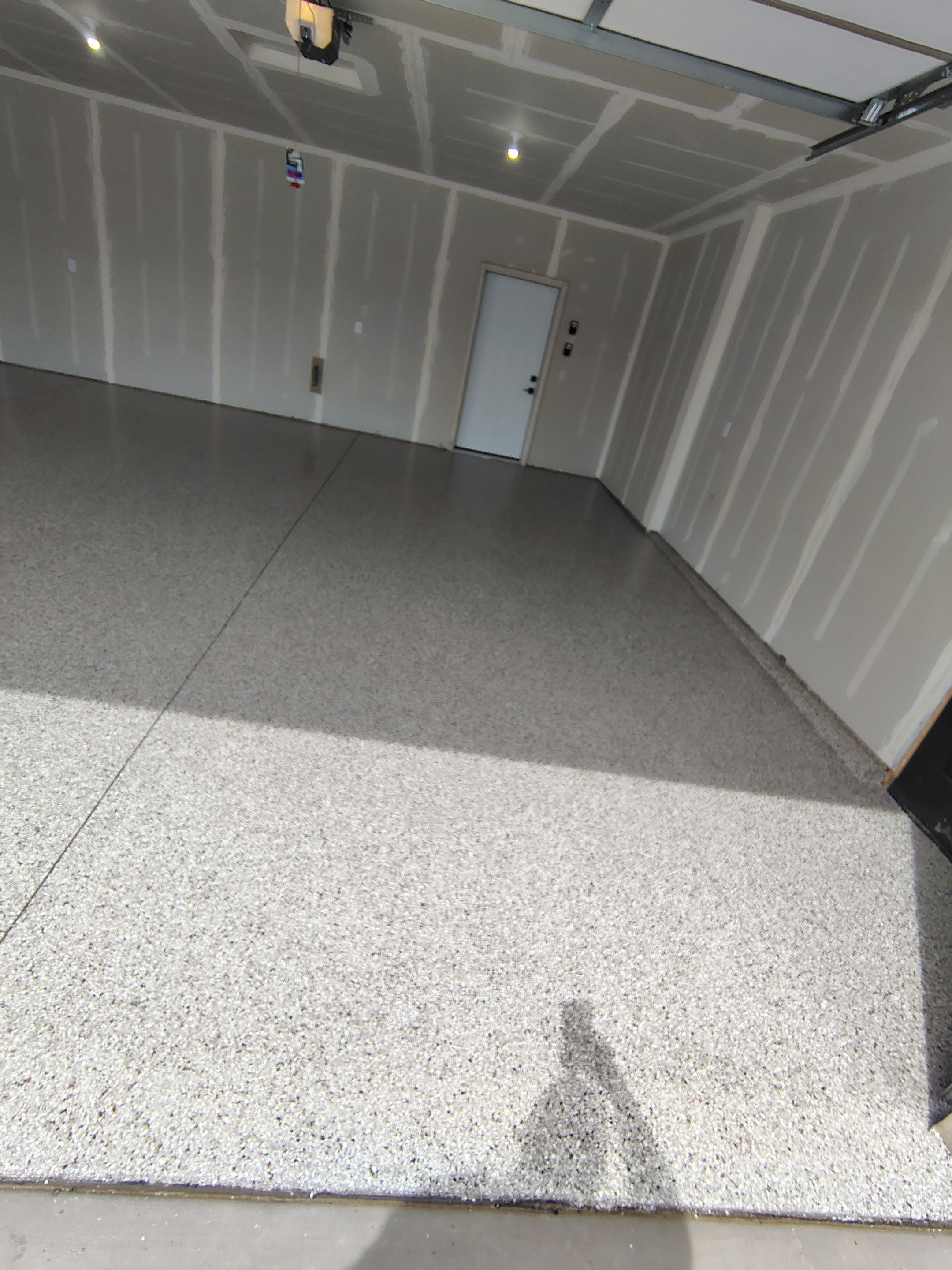 Speckled Epoxy Garage Floor Coating Installation in Sioux Falls by Select Painting, Coatings & Garage Cabinets
