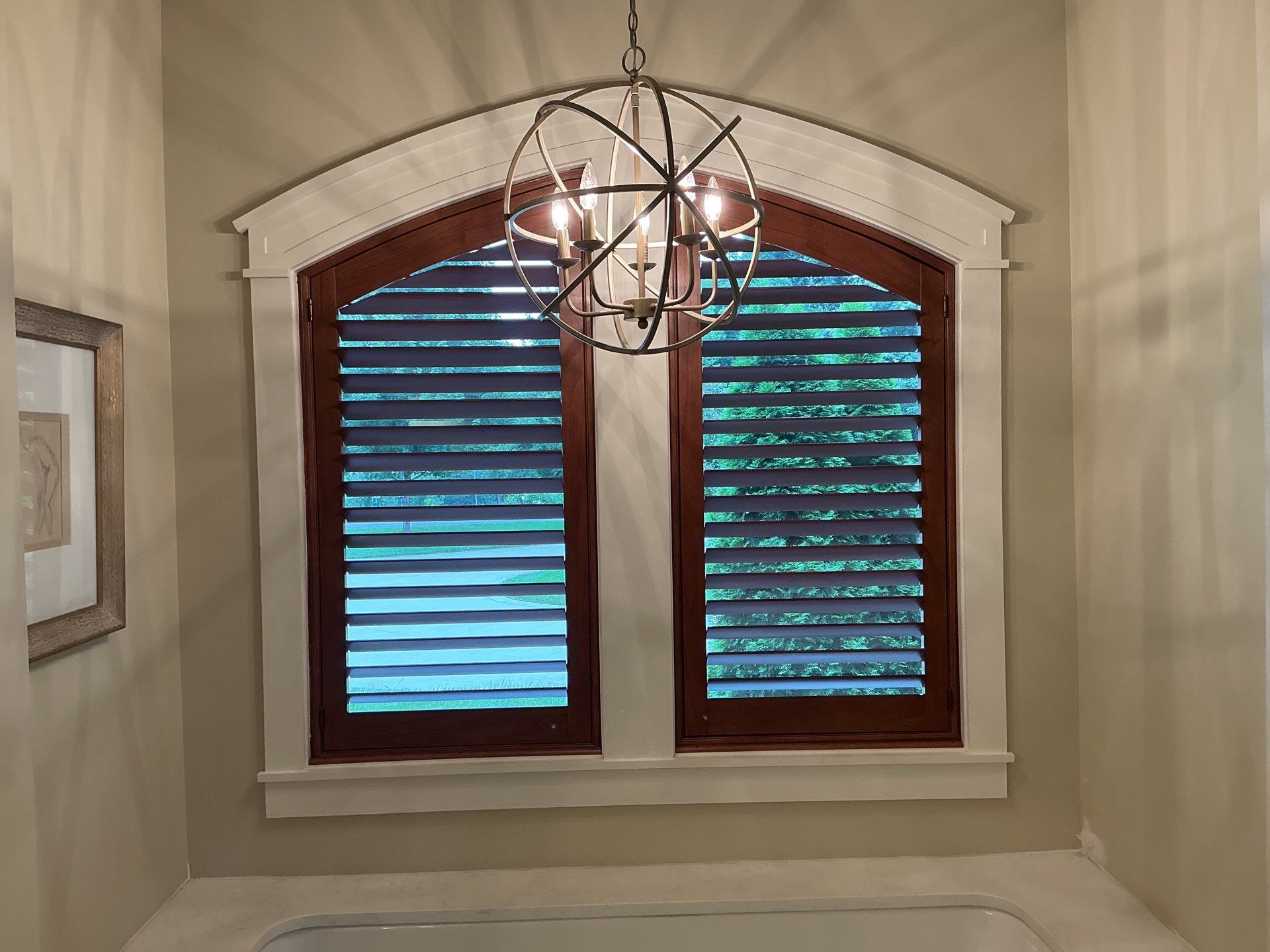 Stained Wood Plantation Shutter Upgrade for Arched Windows in St Joseph by tracy.hickman@budgetblinds.com