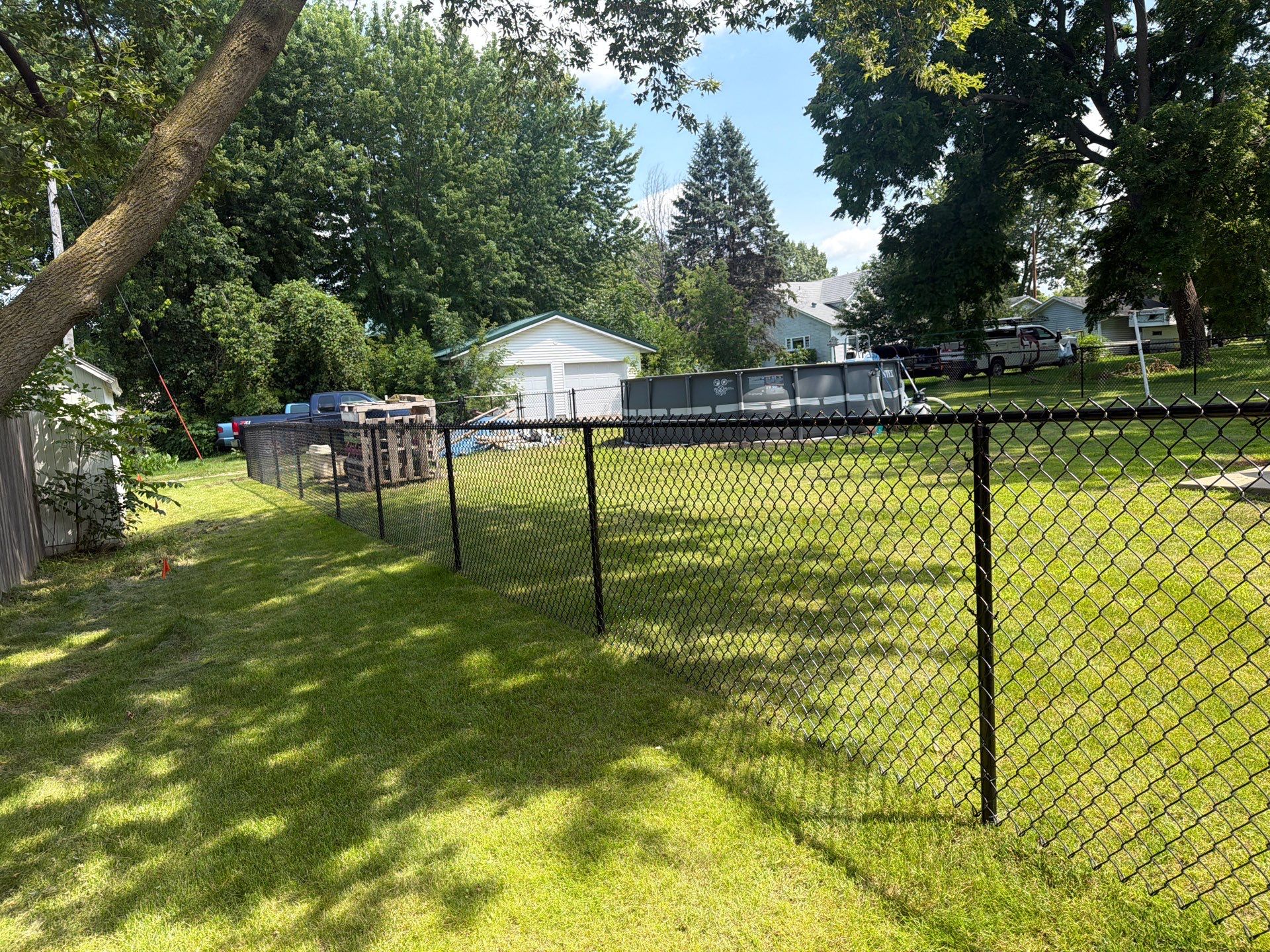 Black Chain Link Backyard Fence Installation in Tripoli, IA by Perfect Picket Fence and Stain