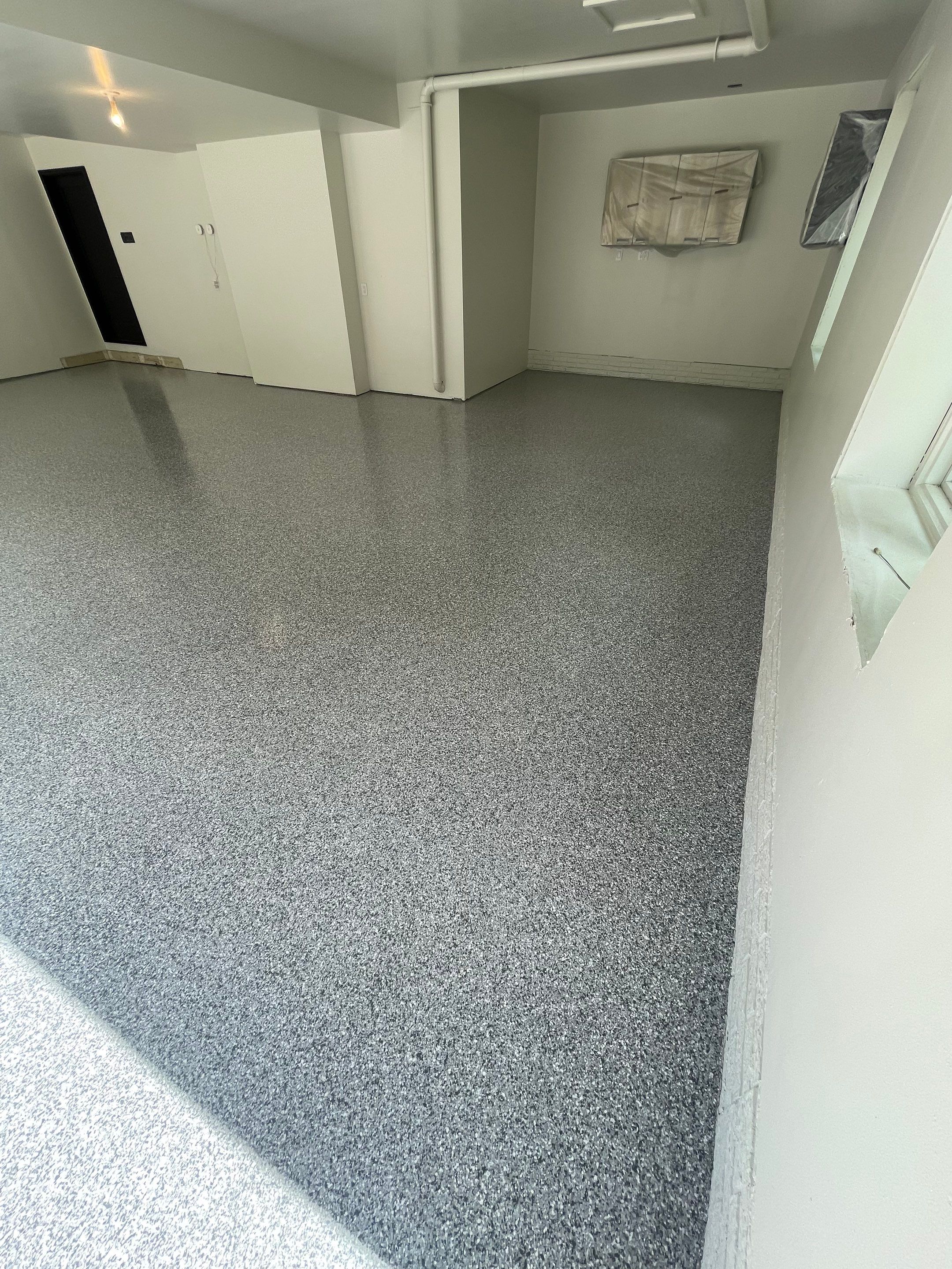 Gray Speckled Epoxy Garage Floor Coating in Sioux Falls by Select Painting, Coatings & Garage Cabinets