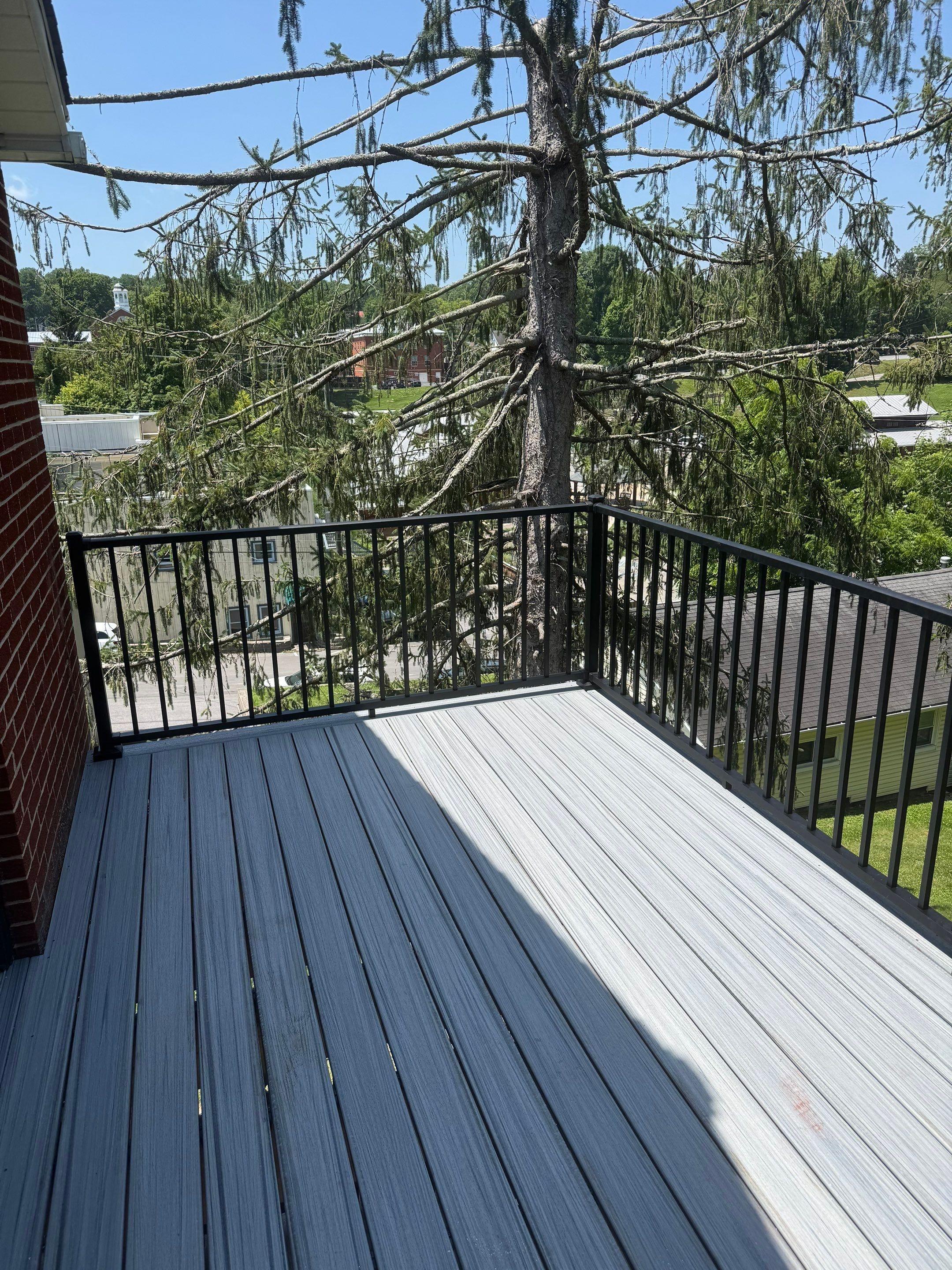 Elevated Composite Deck Rebuild with Black Metal Railing in Lewisburg by Walnut Hollow Decks & Outdoor Living