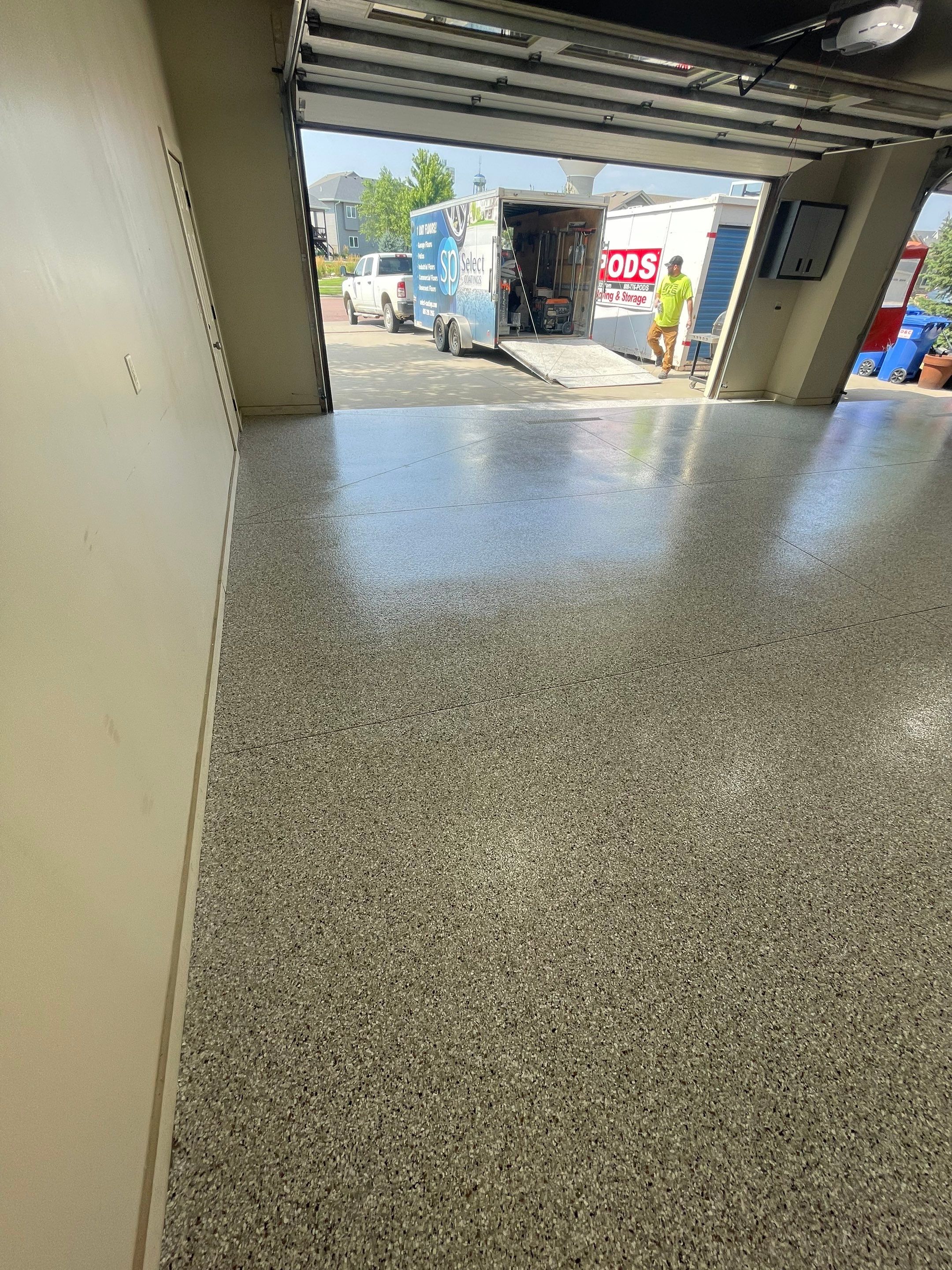 Coyote Flake Garage Floor Coating in Sioux Falls with Trench Drain by Select Painting, Coatings & Garage Cabinets
