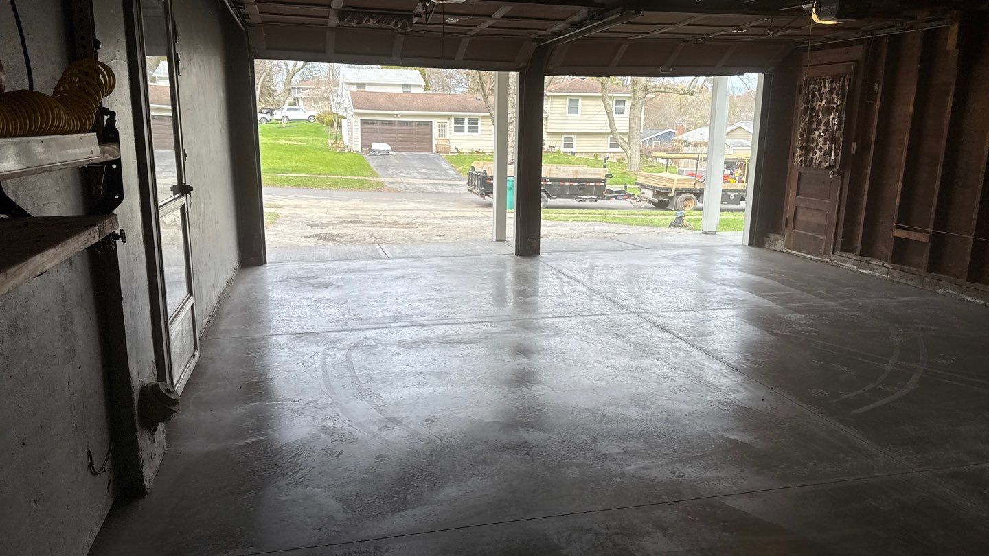 Concrete garage floor replacement with a broom finished apron and sidewalk by NG Masonry & Construction LLC