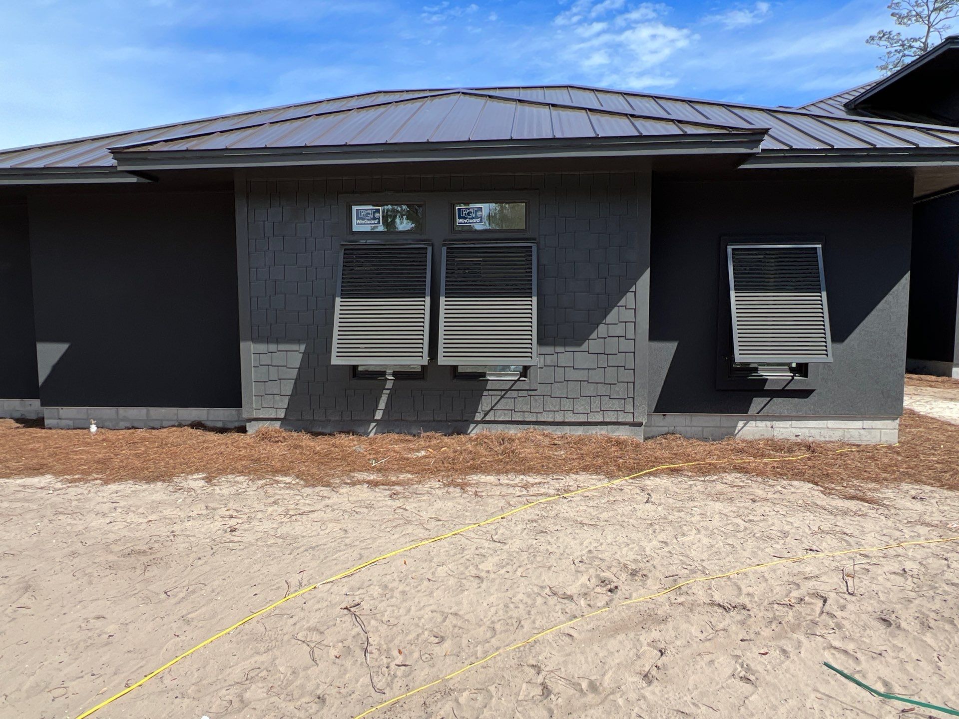 Bahama Shutters in Umbra Grey by Smart Guard Shutters