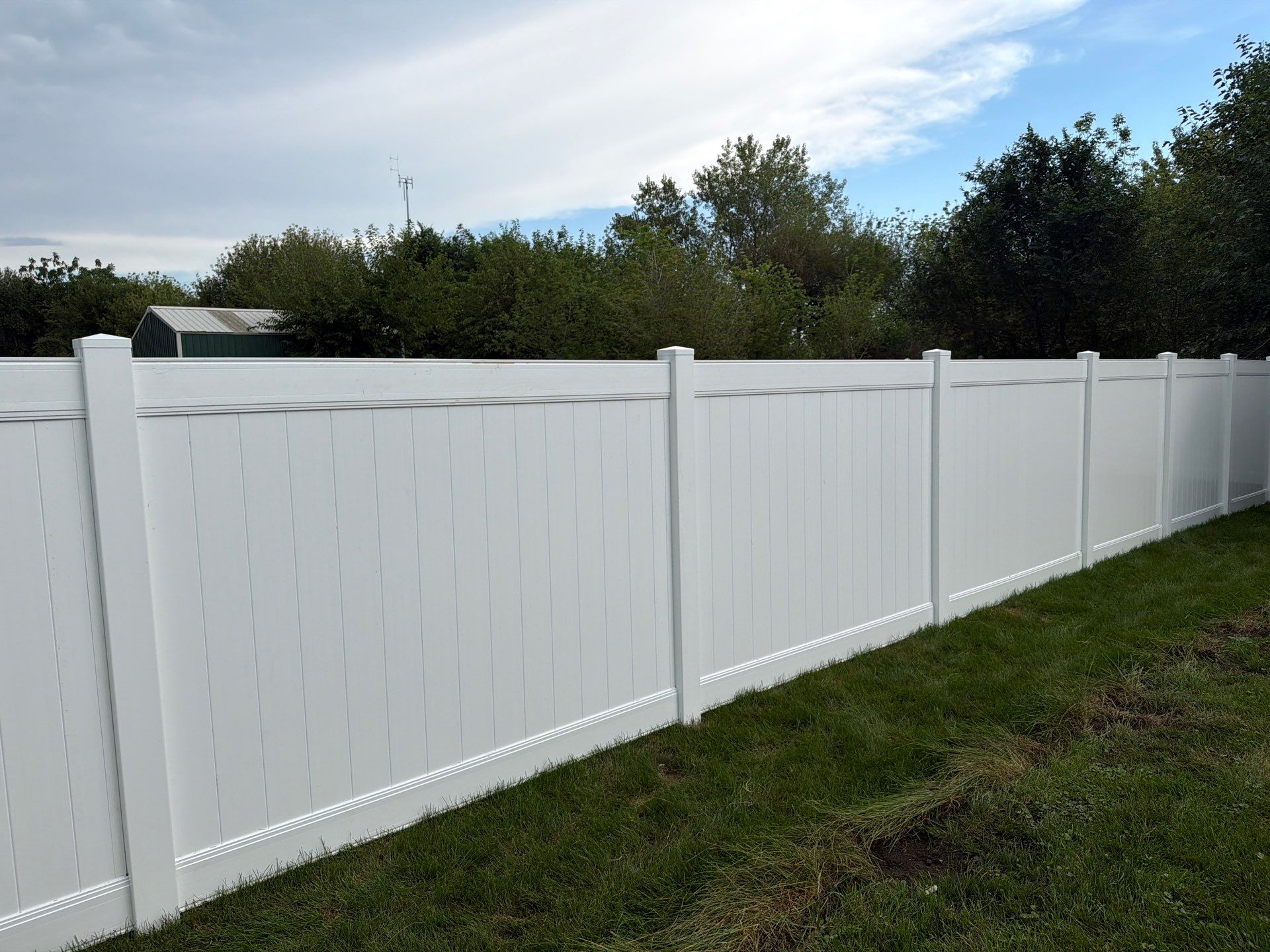 White Vinyl Privacy Fence Installation in Raymond, IA by Perfect Picket Fence and Stain