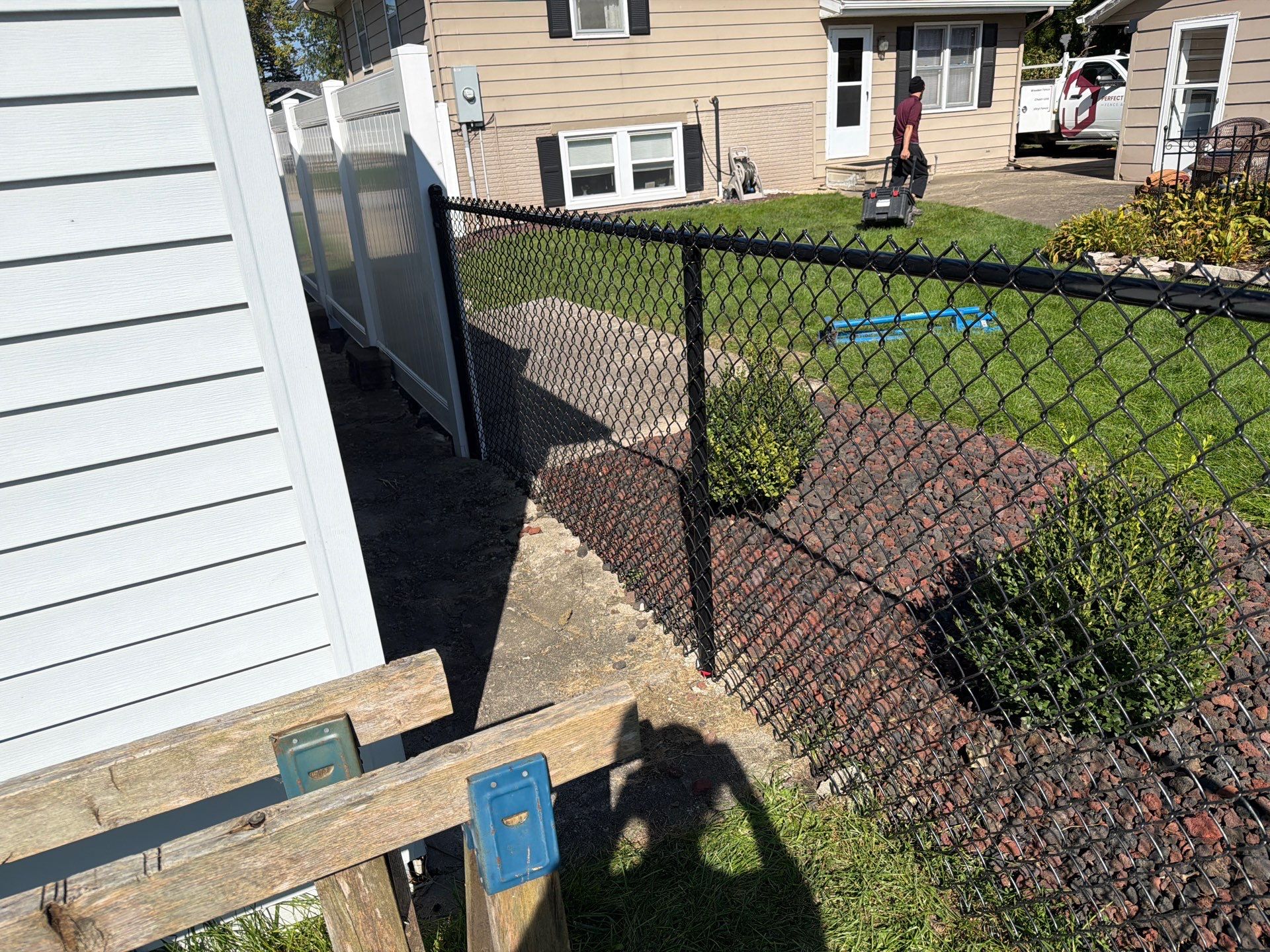Custom Vinyl Privacy and Black Chain Link Fence Installation in Cedar Falls by Perfect Picket Fence and Stain