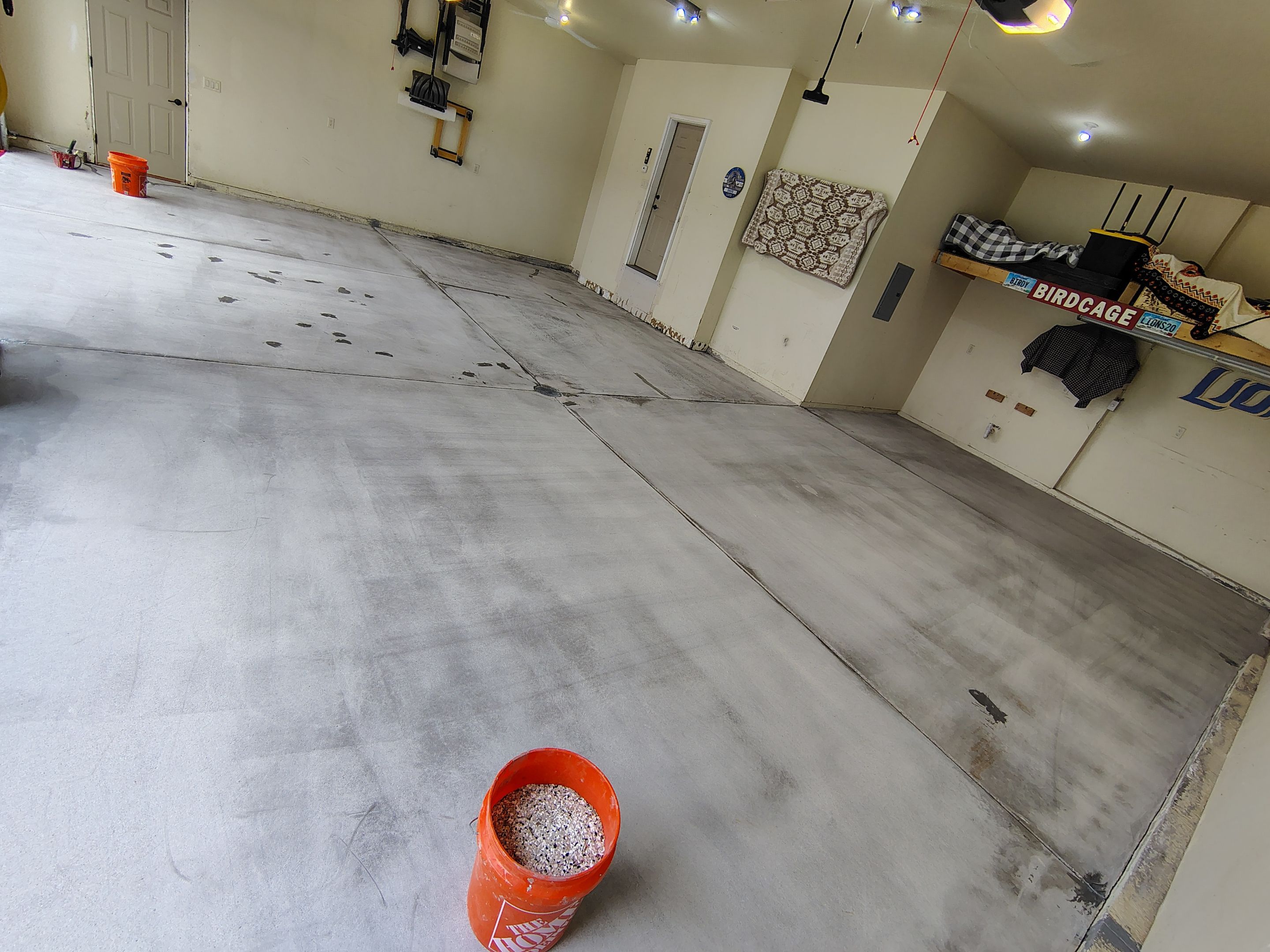 Sioux Falls Garage Floor Repair and Speckled Epoxy Coating Installation by Select Painting, Coatings & Garage Cabinets