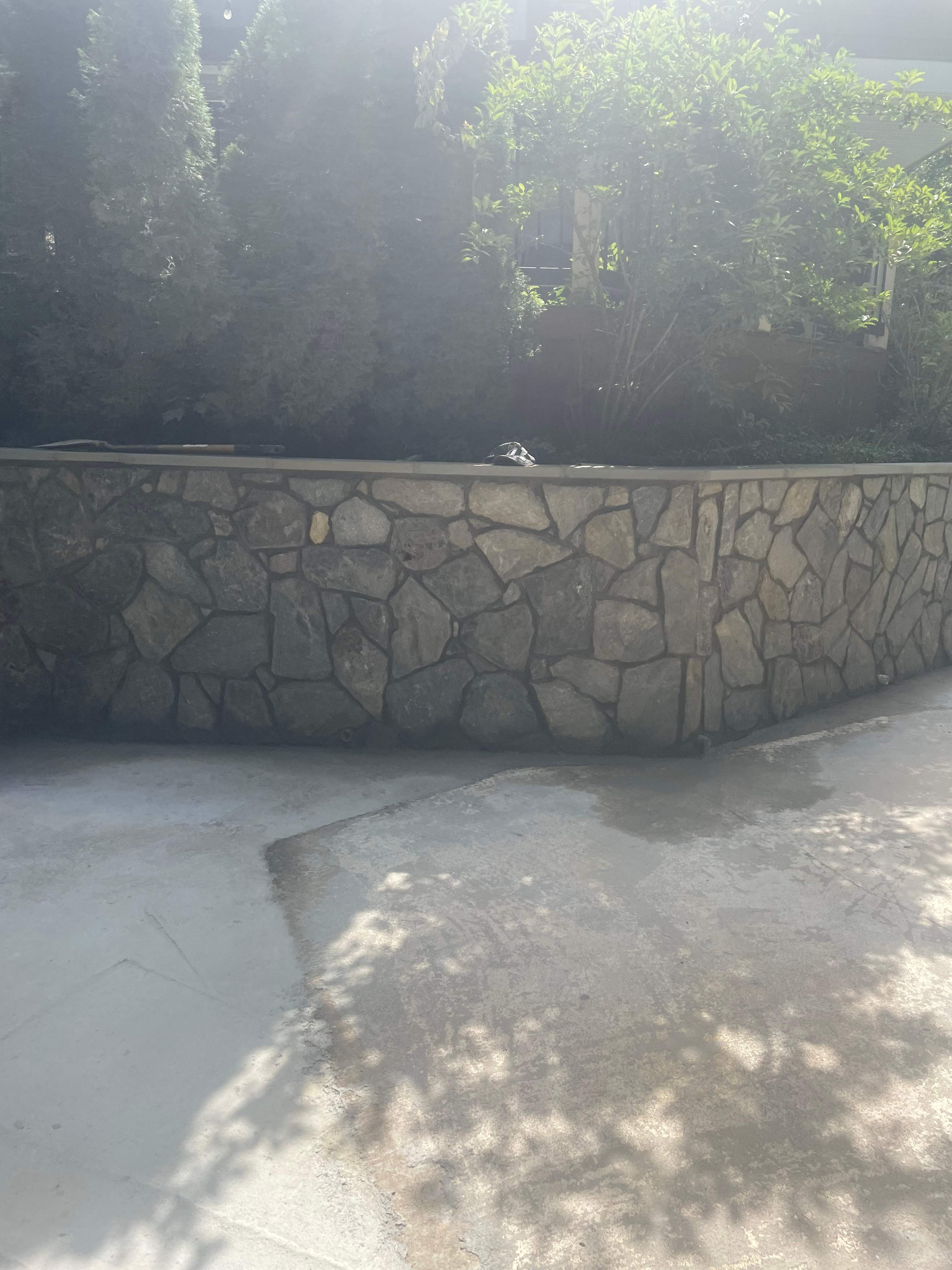 Pool Surround remodel with retaining walls, new waterfall and water slide by Fairfax Contractors, LLC