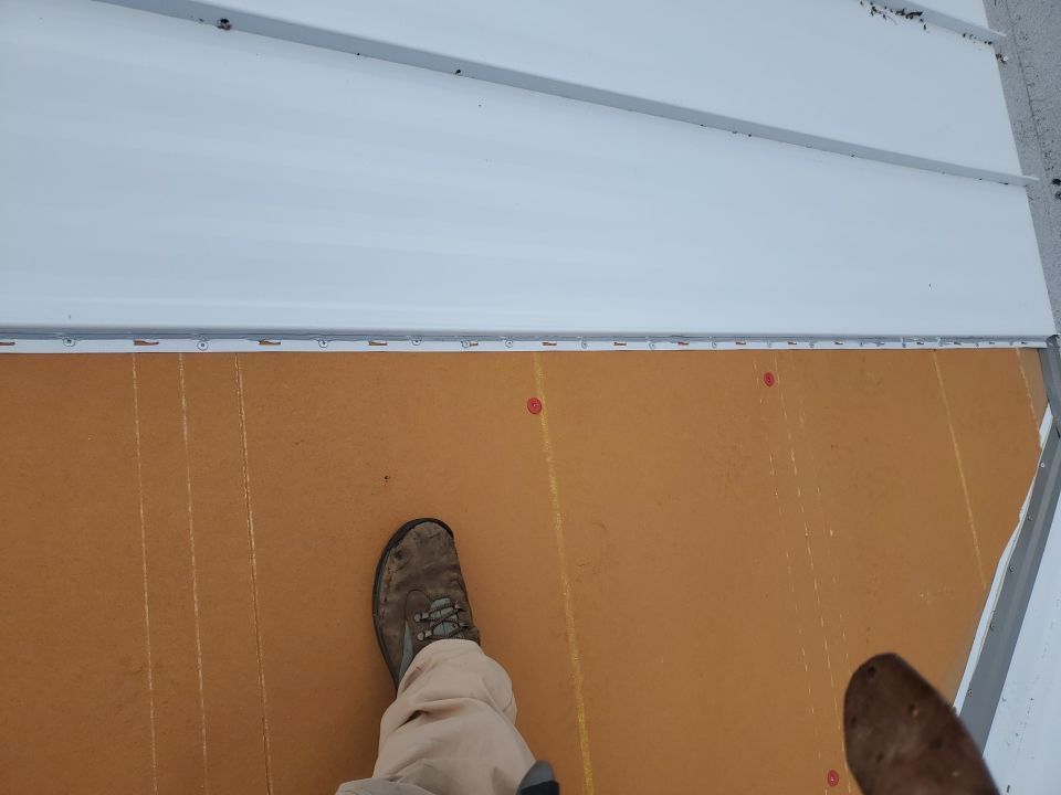 Residential Roofing Installation using 1.5" Nail Strip 24ga Solar White Kynar Coated Standing Seam Metal Panels by Morton Roofing, Inc.