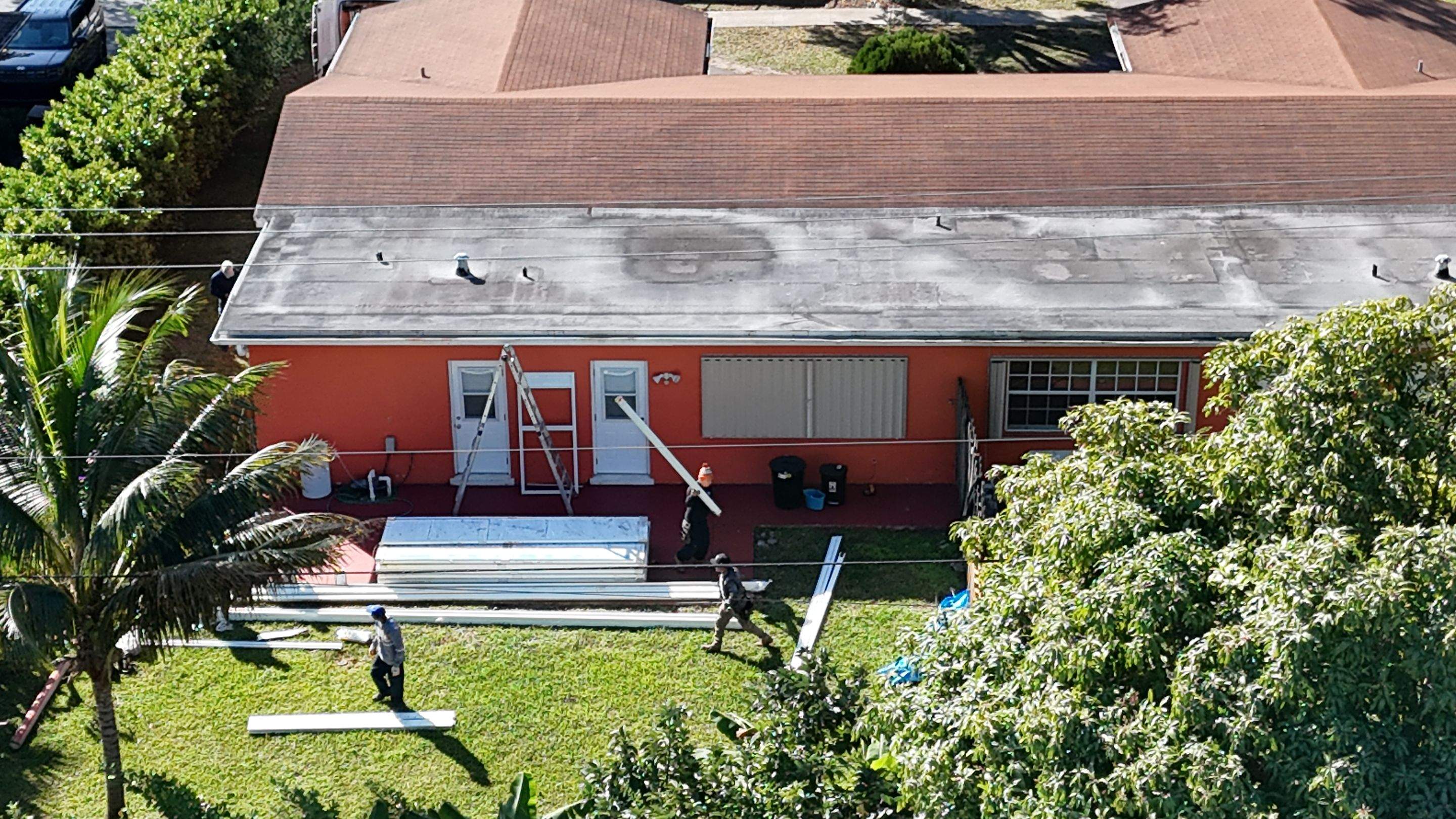 Insulated Screen Enclosure and Wood Tile Deck Installation in Plantation by Aastro Roofing