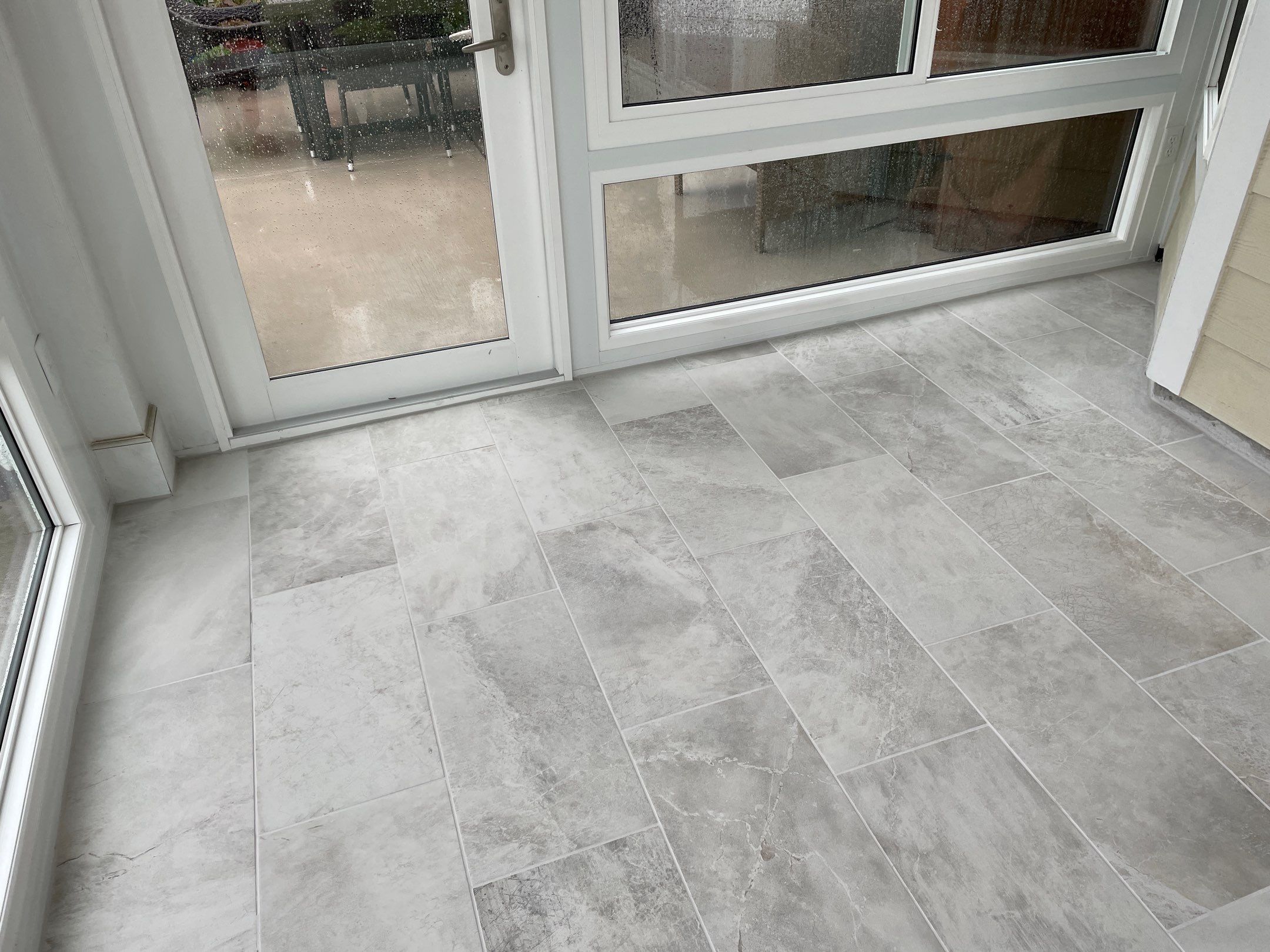 Amazing Tile Transformation After Enclosed Windows Added to Sunroom by Footprints Floors of Coastal Carolina