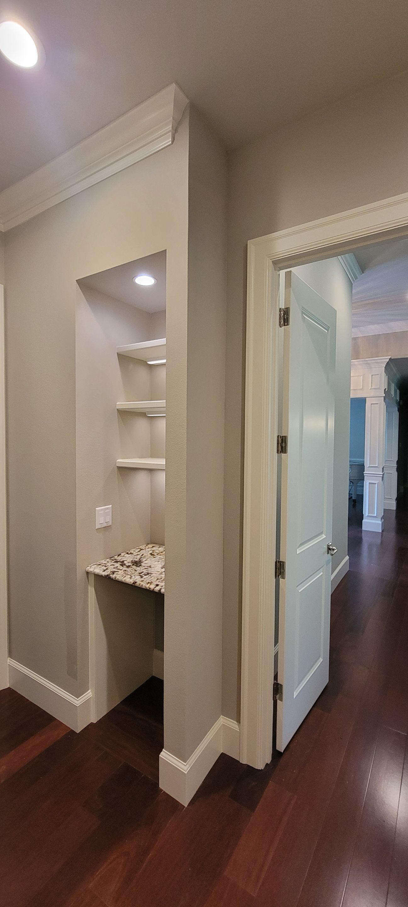 Closet transformation to coffee nook with custom shelves and LED lighting. by Crm Services Llc
