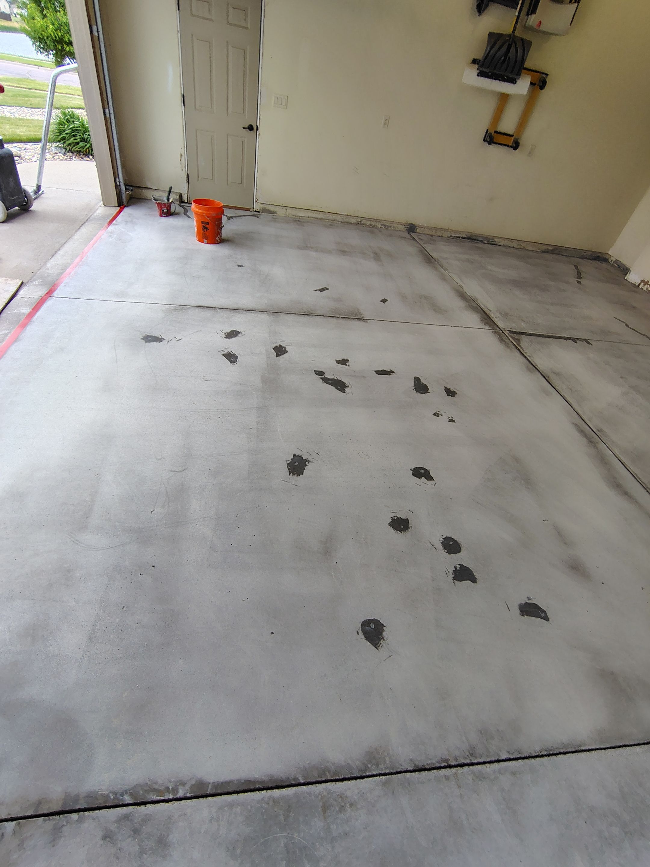 Sioux Falls Garage Floor Repair and Speckled Epoxy Coating Installation by Select Painting, Coatings & Garage Cabinets