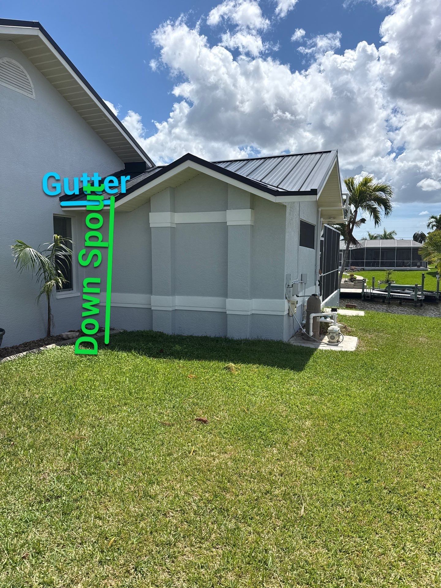 Black Seamless Gutters and White Downspouts in Cape Coral FL by Gutter Professors