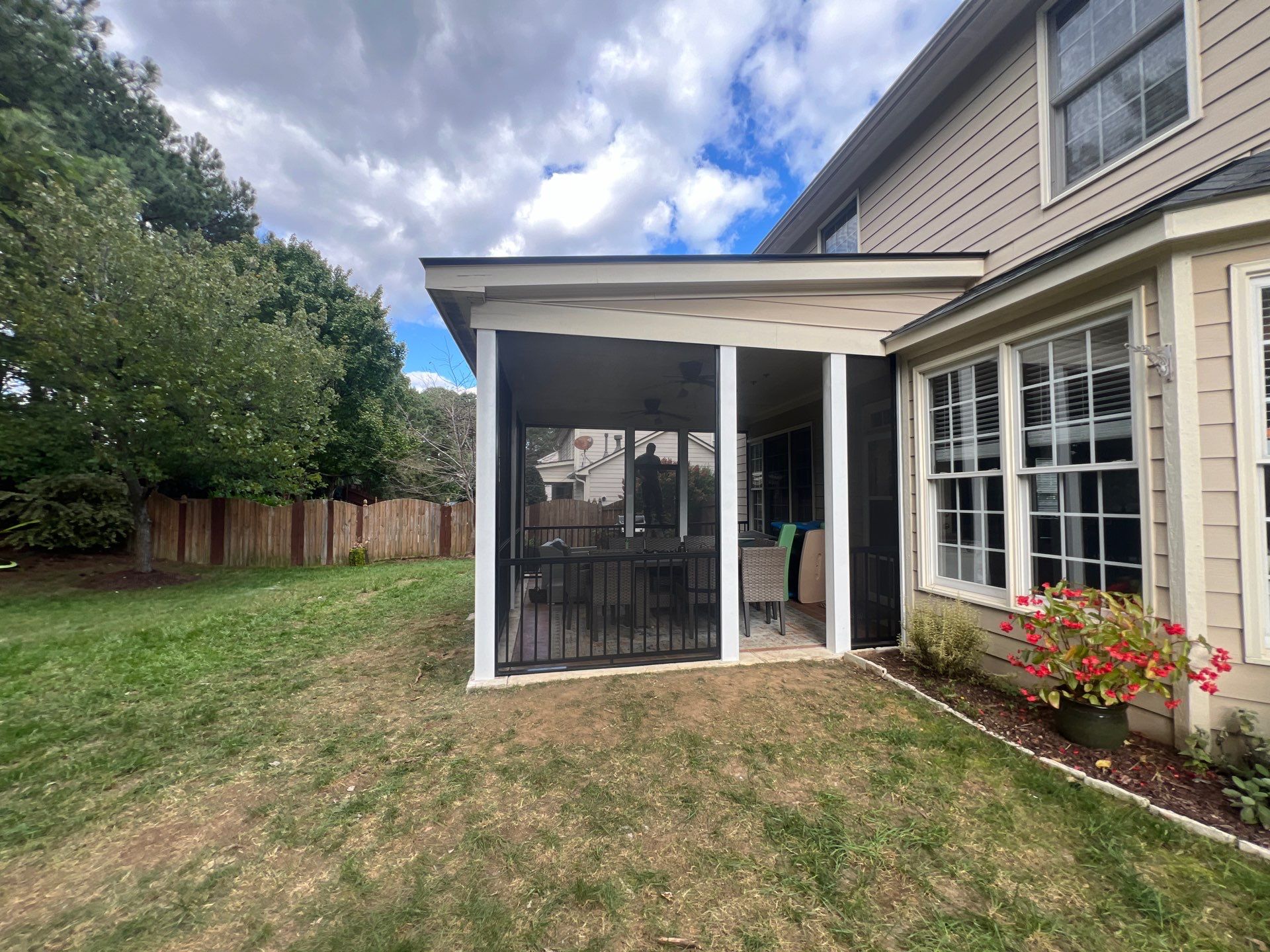 Screened-In Porch Conversion Featuring 6x6 Posts and Black Railings by The Remodeling Company