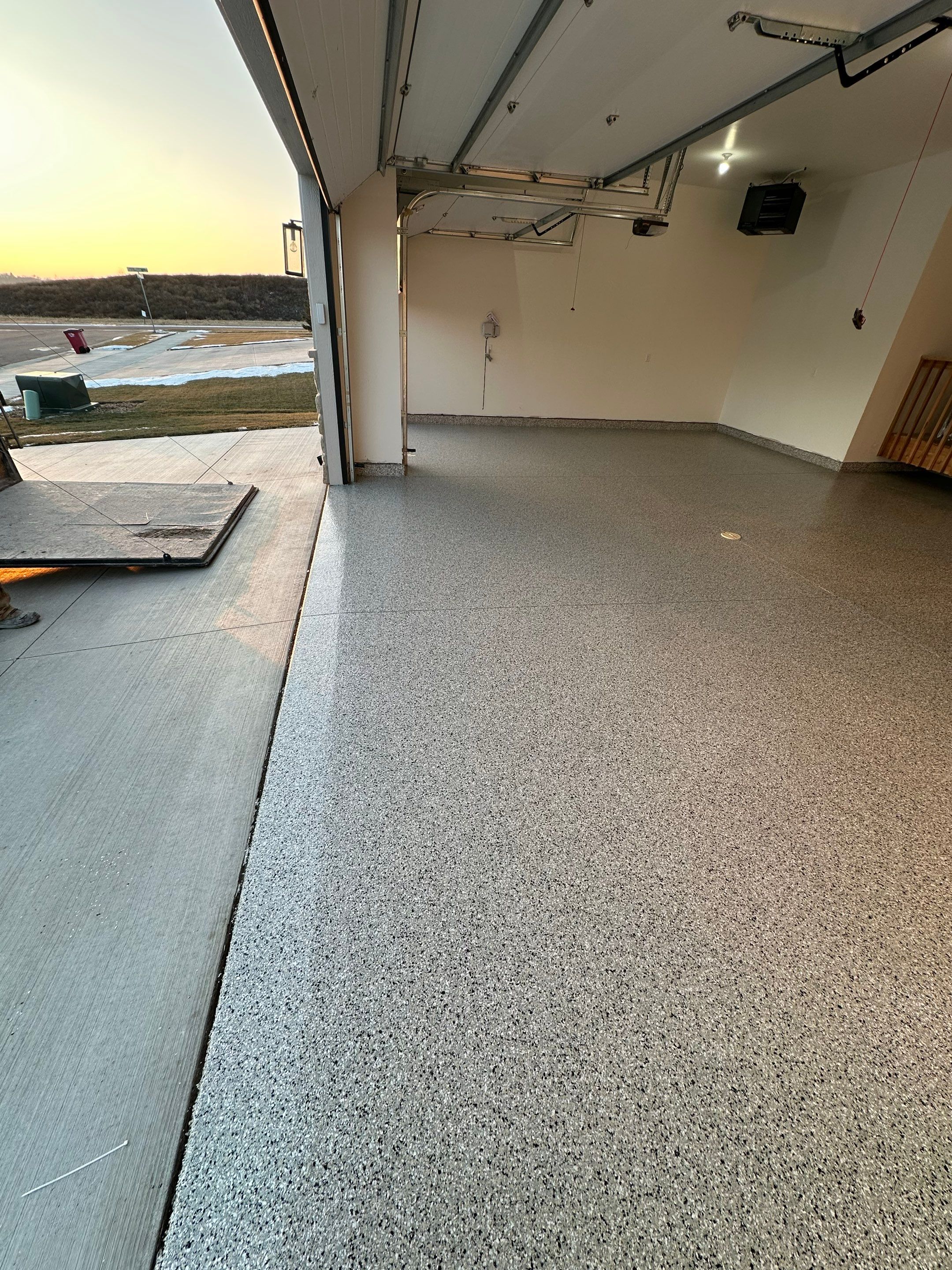 Cabin Fever Decorative Flake Garage Floor Coating in Sioux Falls by Select Painting, Coatings & Garage Cabinets