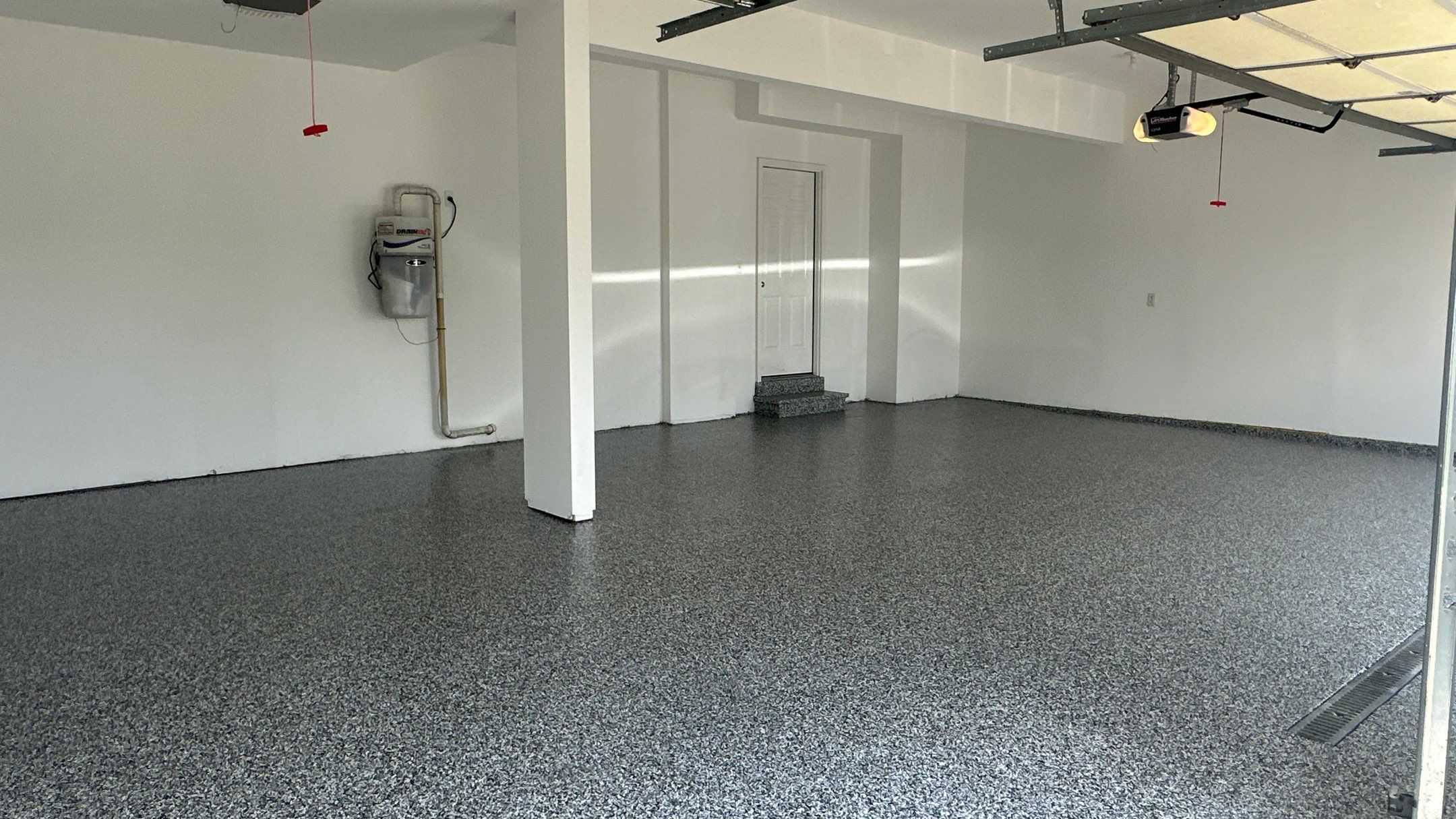 Laura B. garage transformation with a new floor and garage storage  by Banner Garage