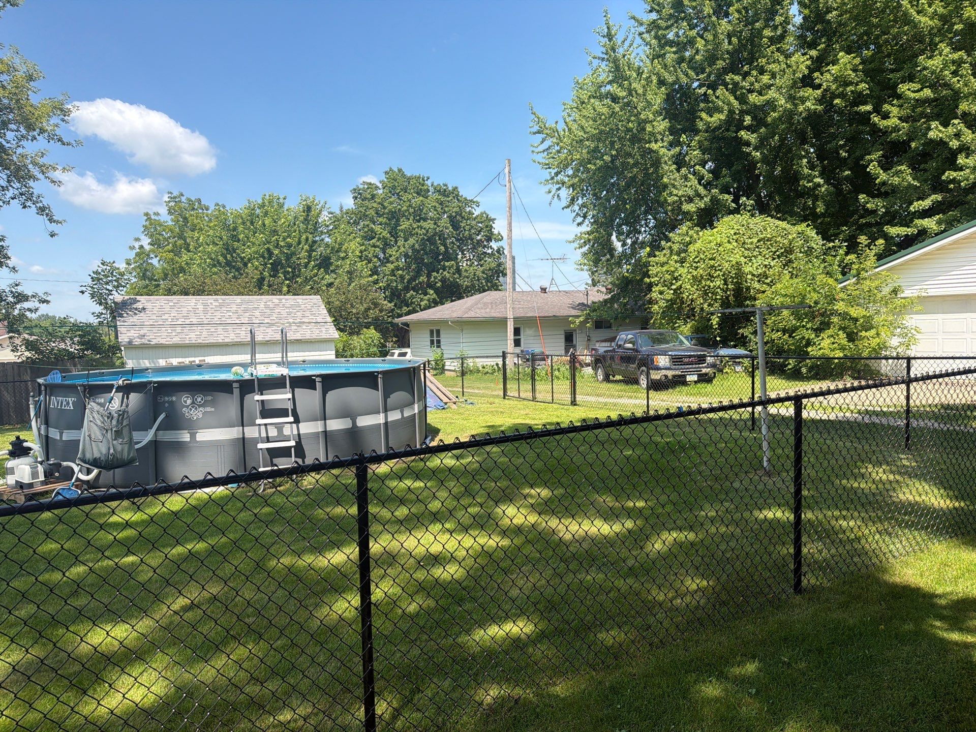 Black Chain Link Backyard Fence Installation in Tripoli, IA by Perfect Picket Fence and Stain