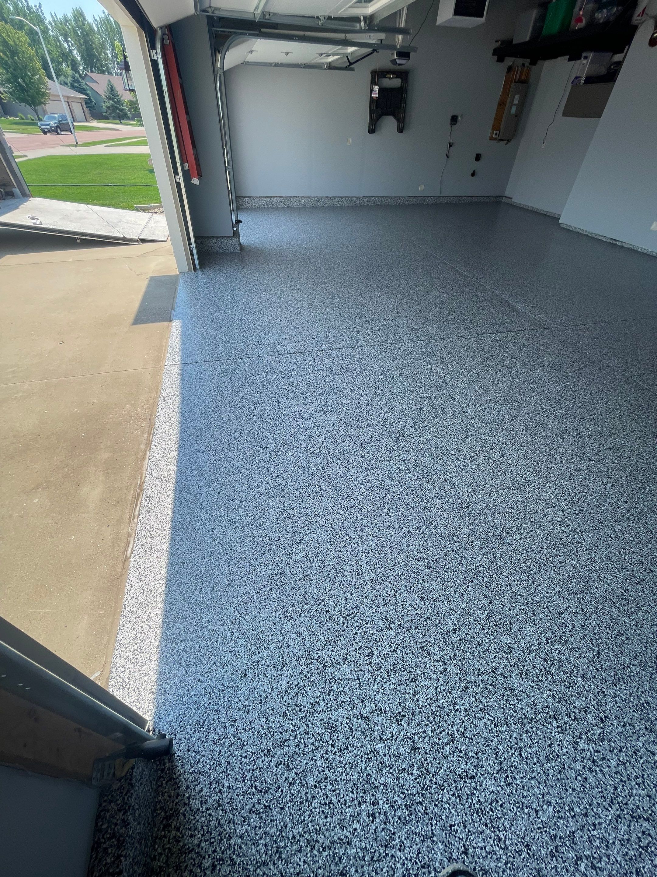 Sioux Falls Garage Concrete Coating Installation with Domino Flake by Select Painting, Coatings & Garage Cabinets