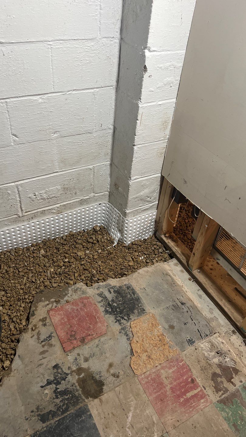 Interior drain tile system installation by ACE Waterproofing & Basement Solutions