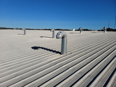 Wide view of metal roof with ventilation pipes