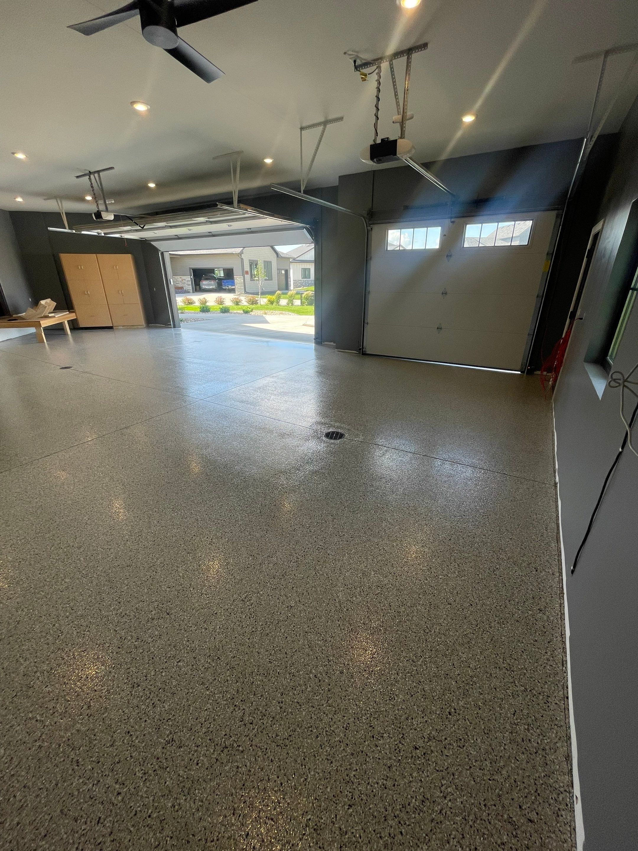 Custom Speckled Concrete Coating for Dell Rapids Garage by Select Painting, Coatings & Garage Cabinets