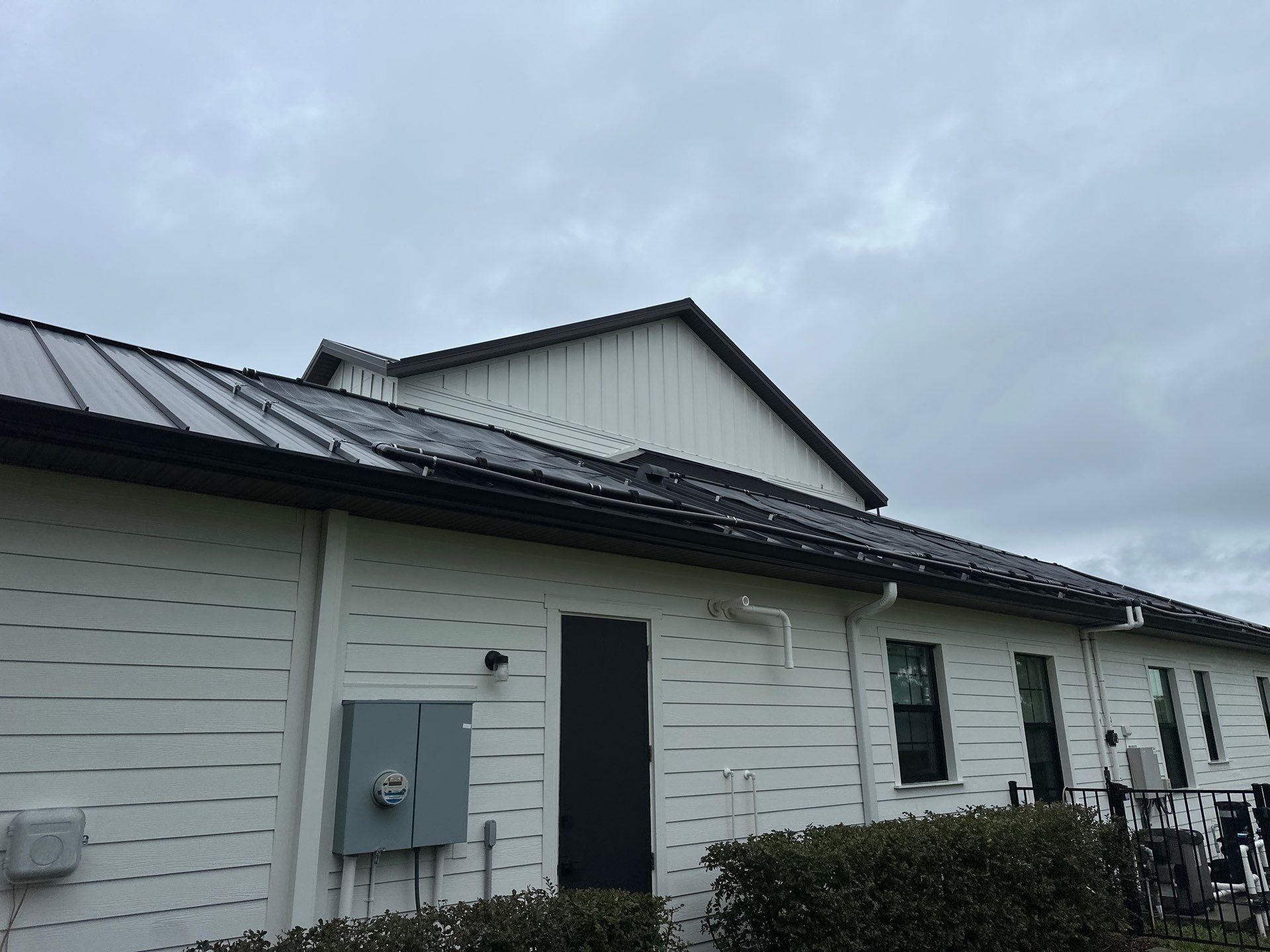 Complete Two-Story House Wash and Driveway Cleaning in Winding River Community, Bradenton, FL by Sunshine AquaWash