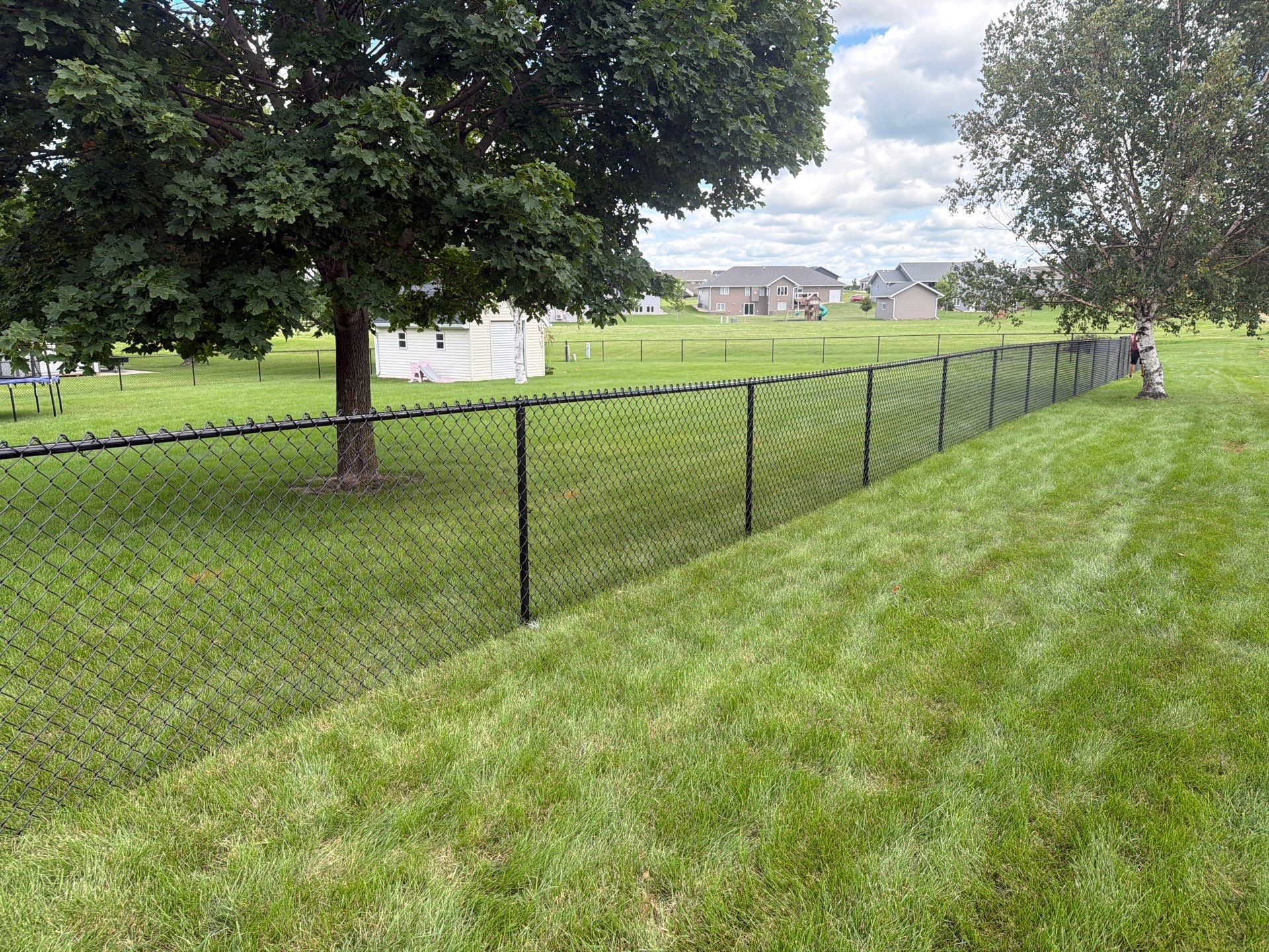 Black Vinyl-Coated Chain Link Fence Installation in Fairbank by Perfect Picket Fence and Stain