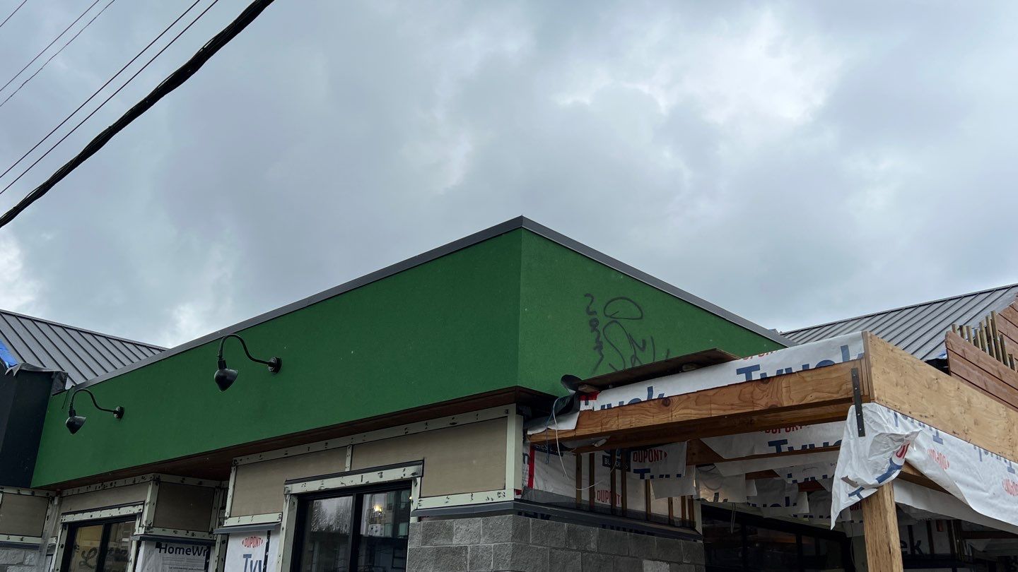 Commercial Roofing Installation using 12" Prolok metal and hidden gutters! by Top Notch Roofing Inc