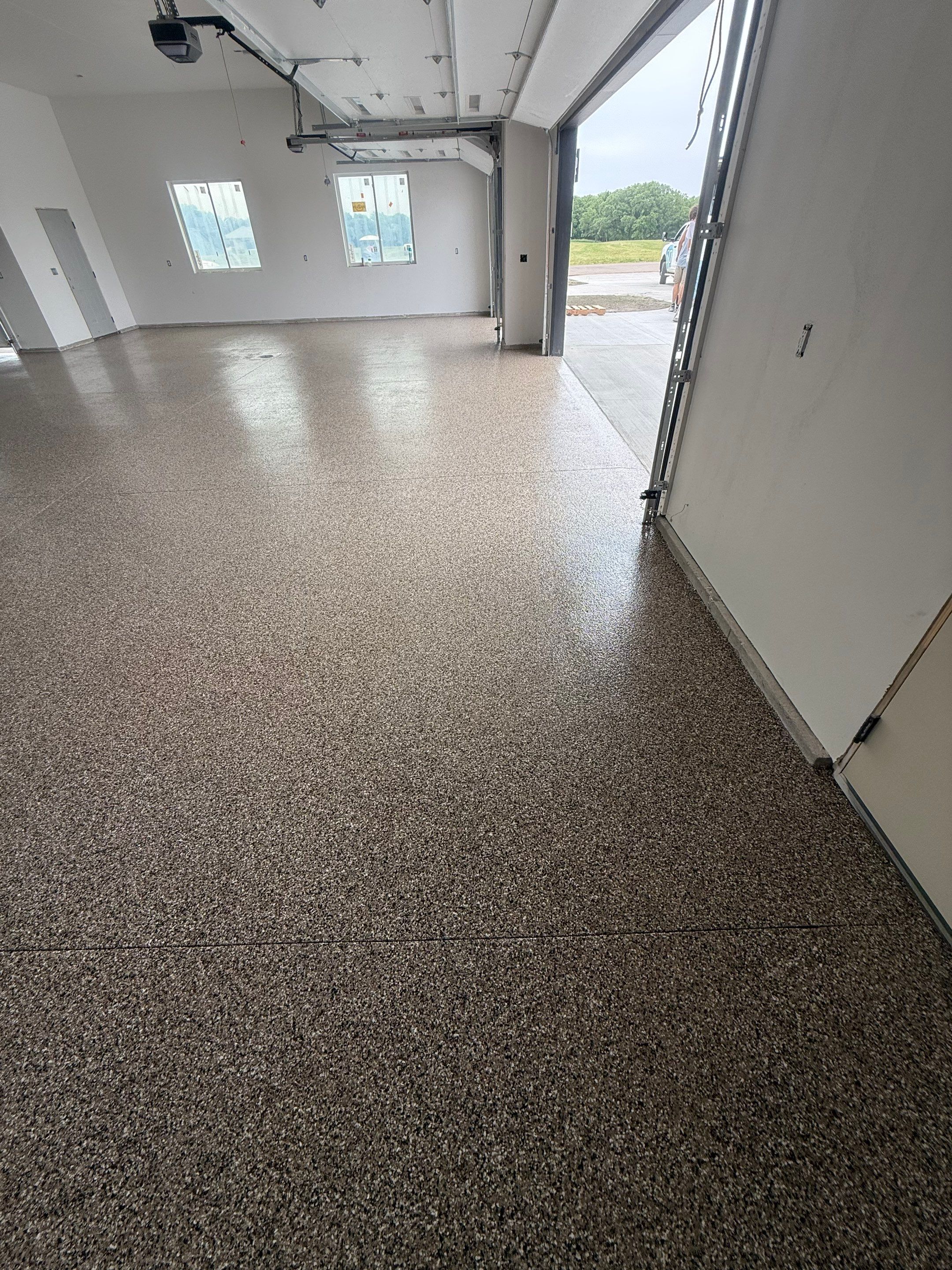 Multi-Bay Garage Concrete Coating and Floor Refinishing in South Dakota by Select Painting, Coatings & Garage Cabinets