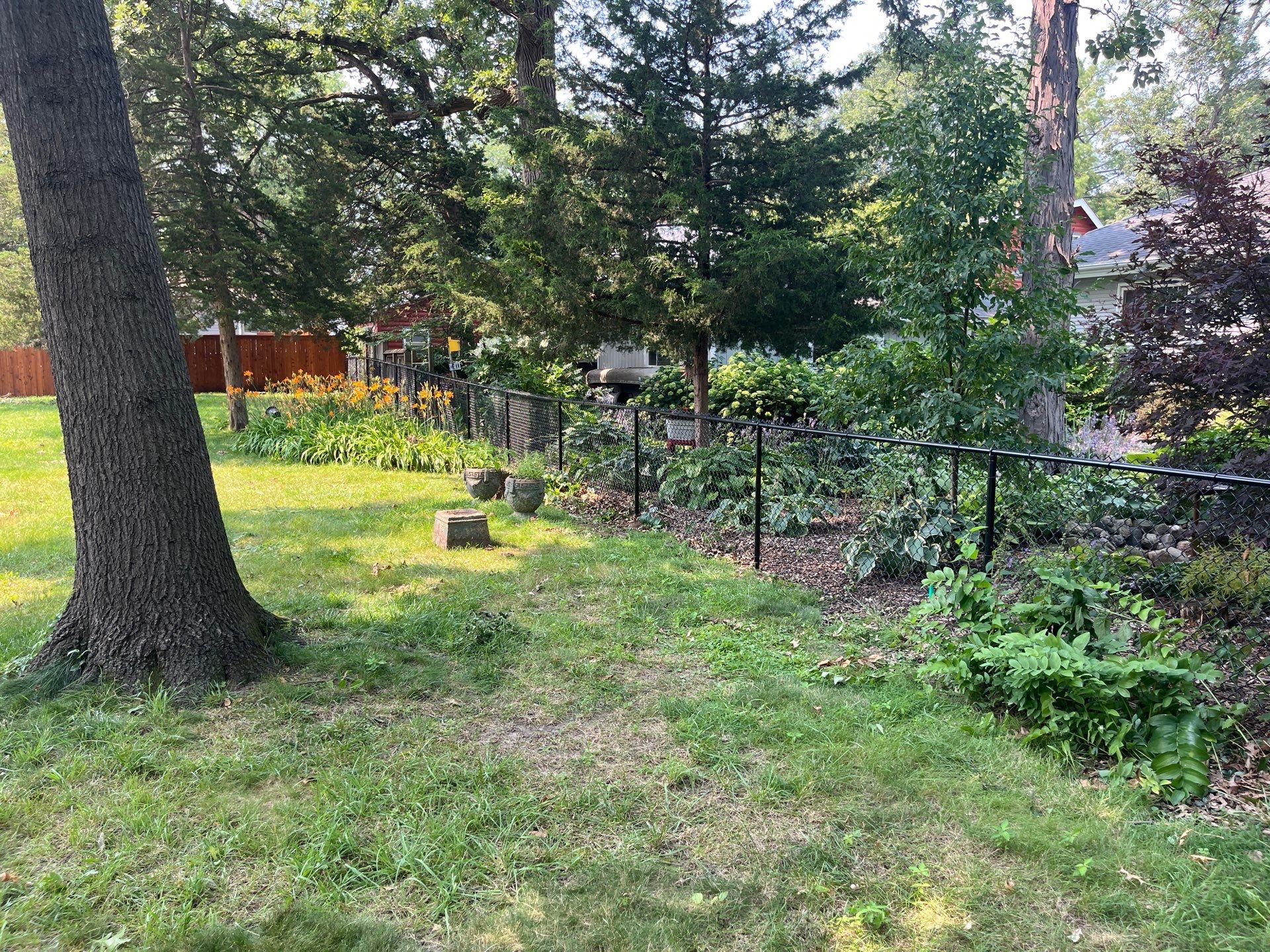 Residential Black Chain Link Fence Installation in Cedar Falls by Perfect Picket Fence and Stain