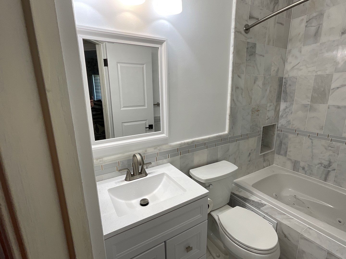 Bathroom Remodel using Two new bathroom design and new floors by Alpha Design Services