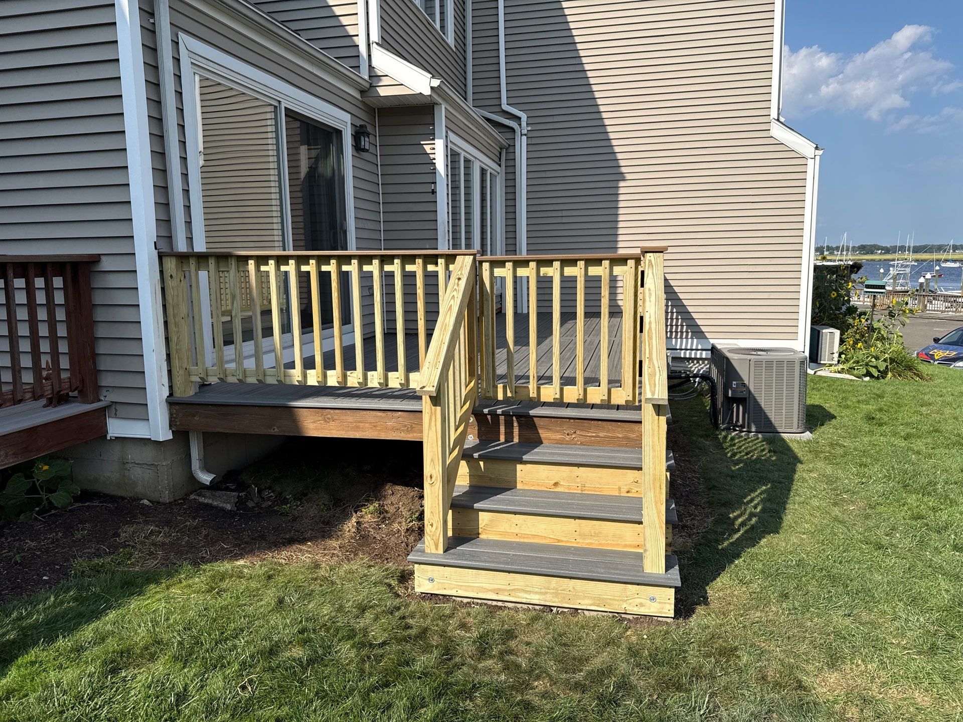 Deck replacement using trex Tropical Island mist and Pressure treated railings. by DiGiorgi Roofing and Siding Inc