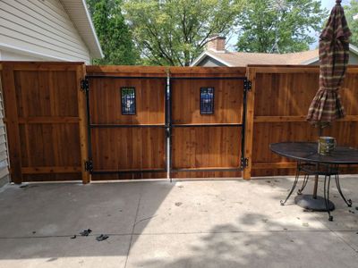 Custom Cedar Privacy Fence with Decorative Gate Windows in Cedar Falls