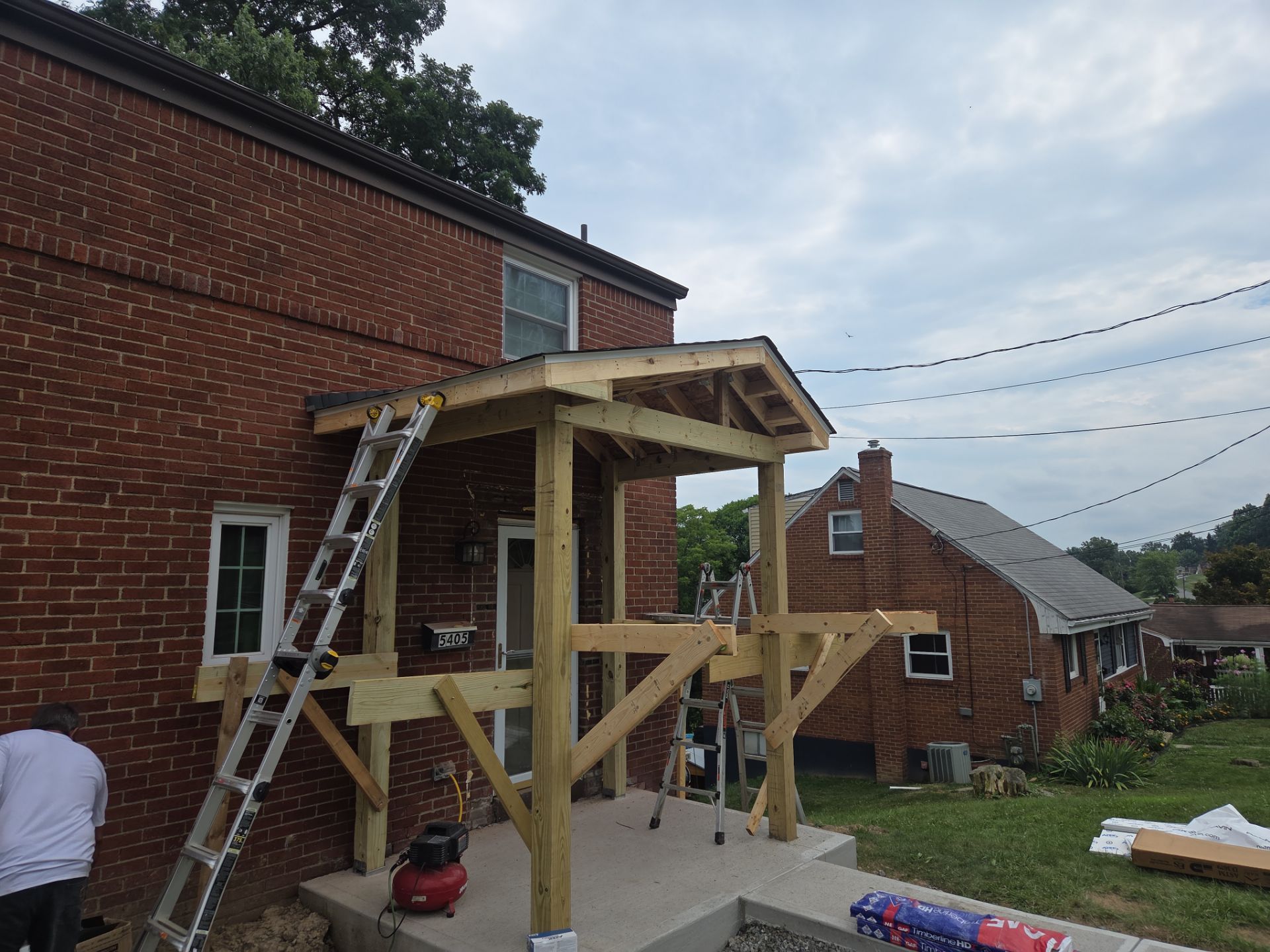Concret and roof build  by Cousins Roofing Siding & Decks