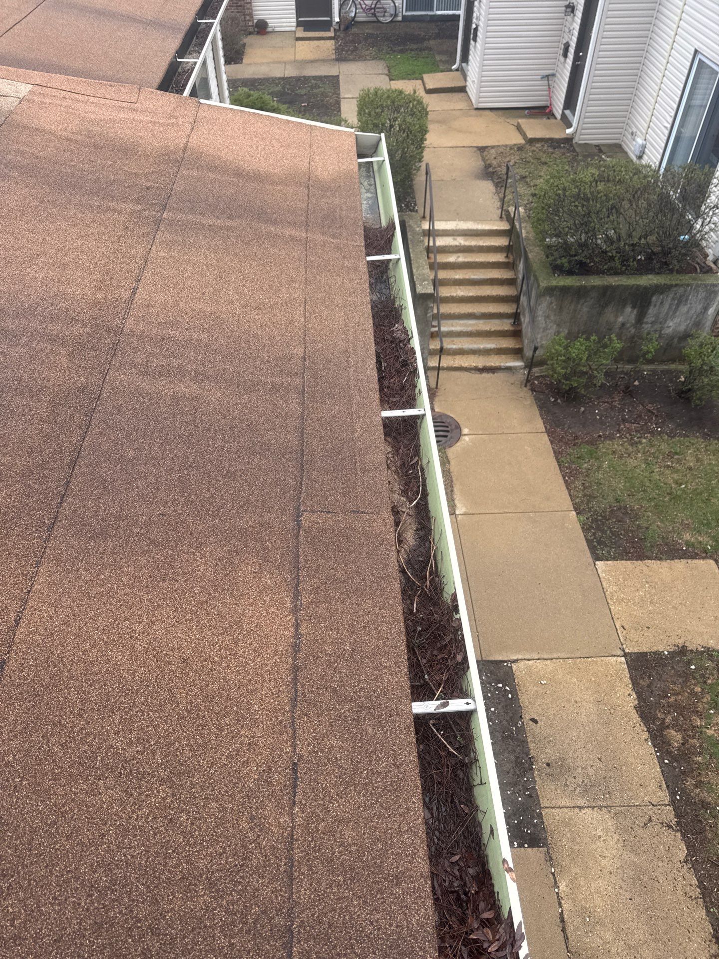 Commercial gutter cleaning Joliet, IL before photo with filled gutters