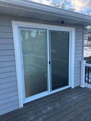 New deck construction and replacement of window with new sliding door