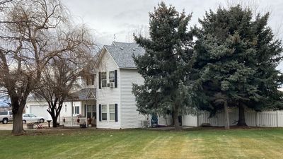 Two story farmhouse style roofing installation using Owens Corning Duration in the color Teak