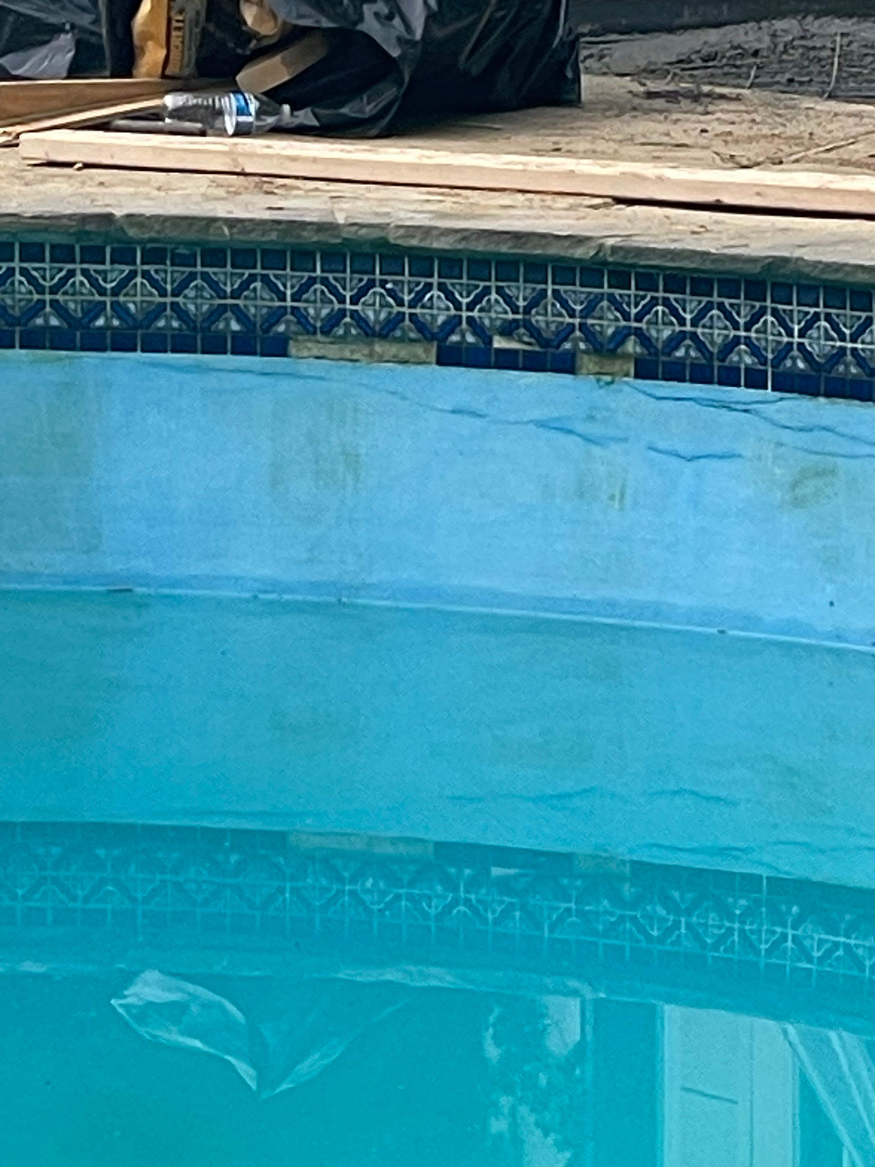 Pool Surround remodel with retaining walls, new waterfall and water slide by Fairfax Contractors, LLC