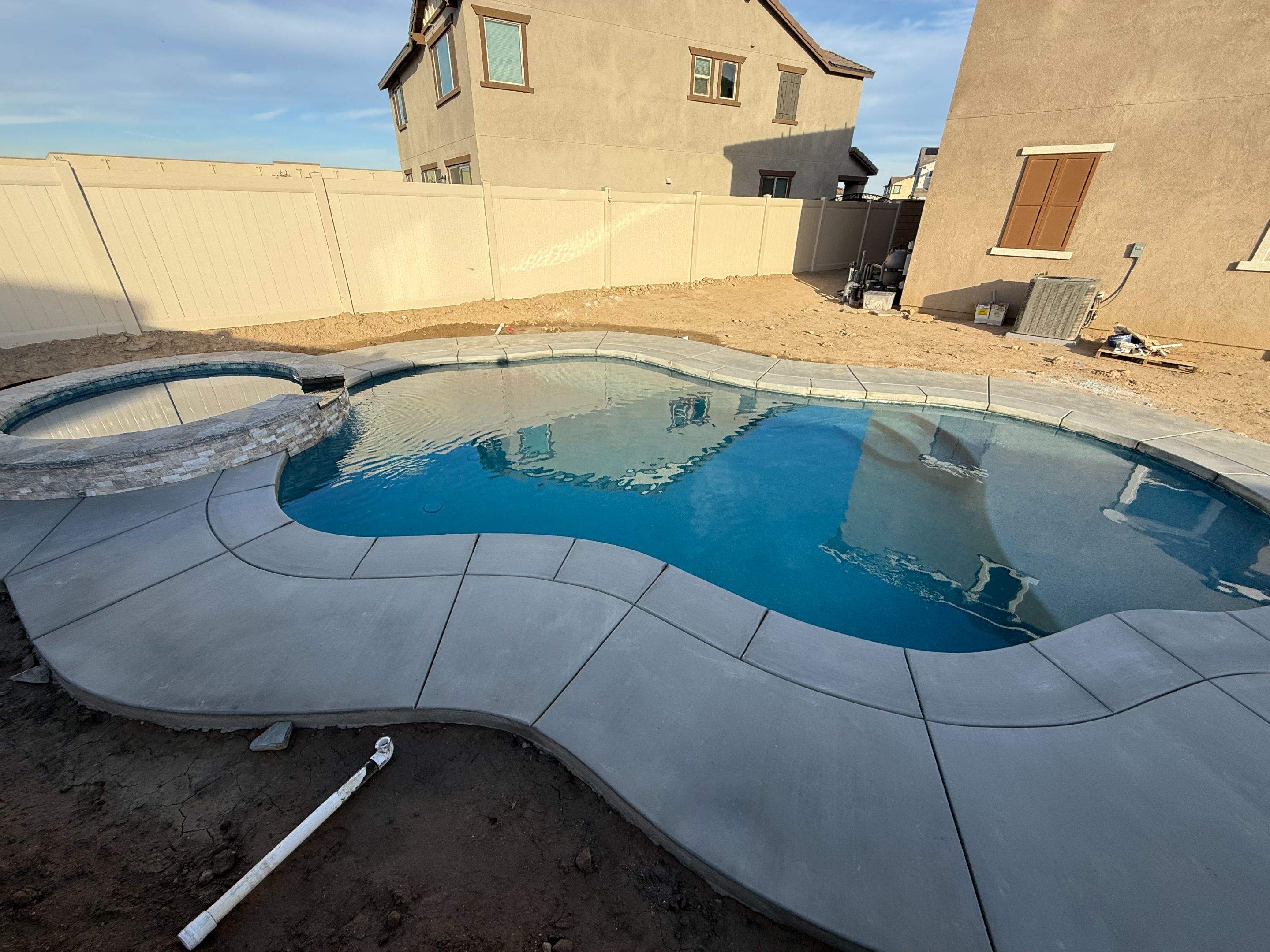 Freeform pool and spa, quartz stone coping on spa, pip on pool by Premier Pools and Spas Temecula