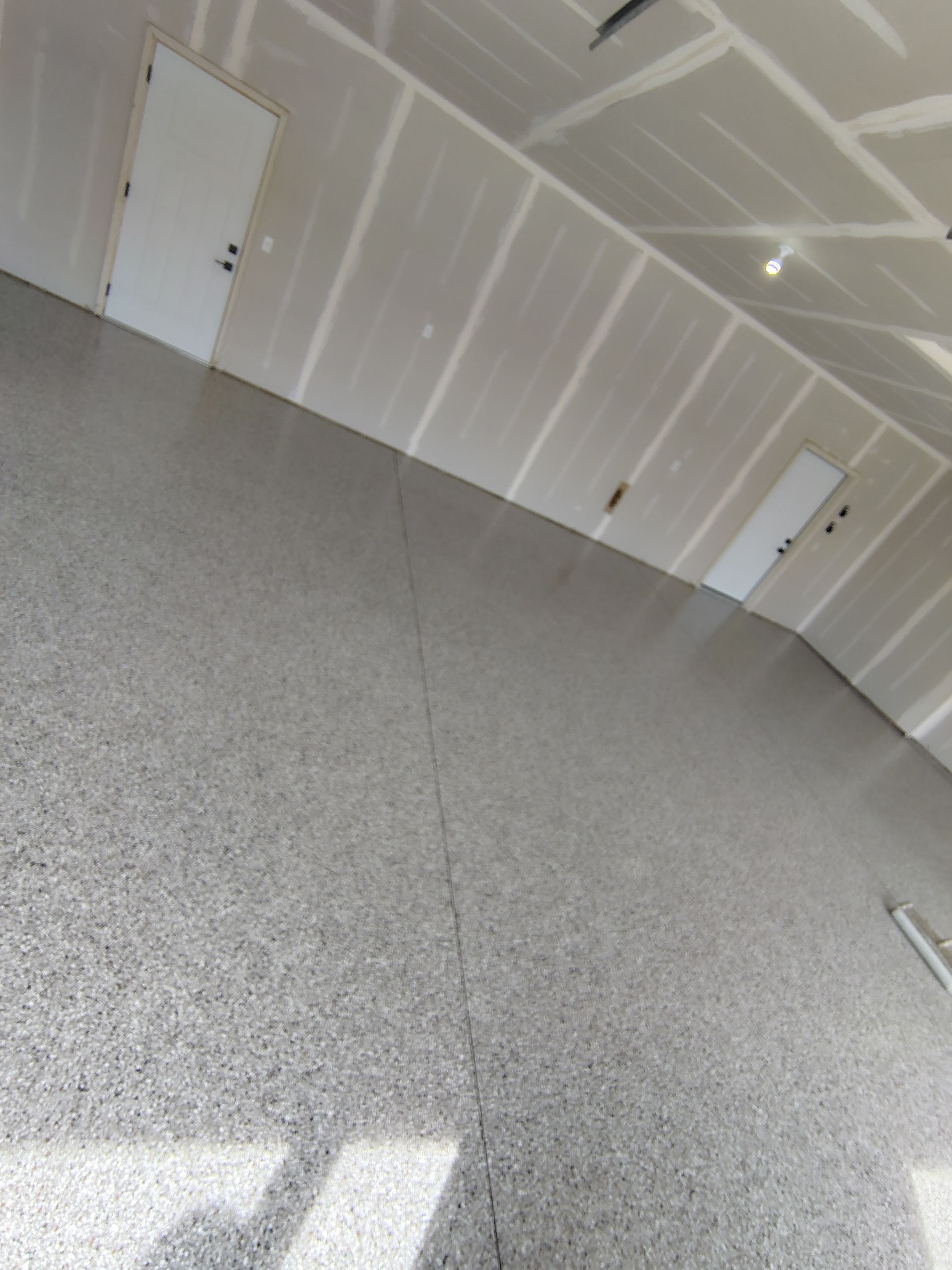 Speckled Epoxy Garage Floor Coating Installation in Sioux Falls by Select Painting, Coatings & Garage Cabinets