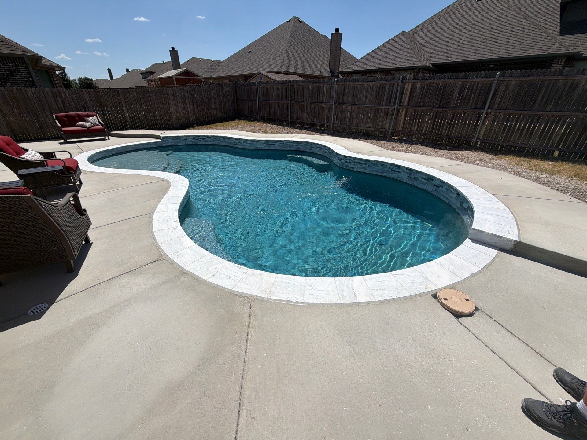 Freeform Pool with Tanning Ledge and Raised Stone Wall by Pinnacle Pools and Spas - DFW